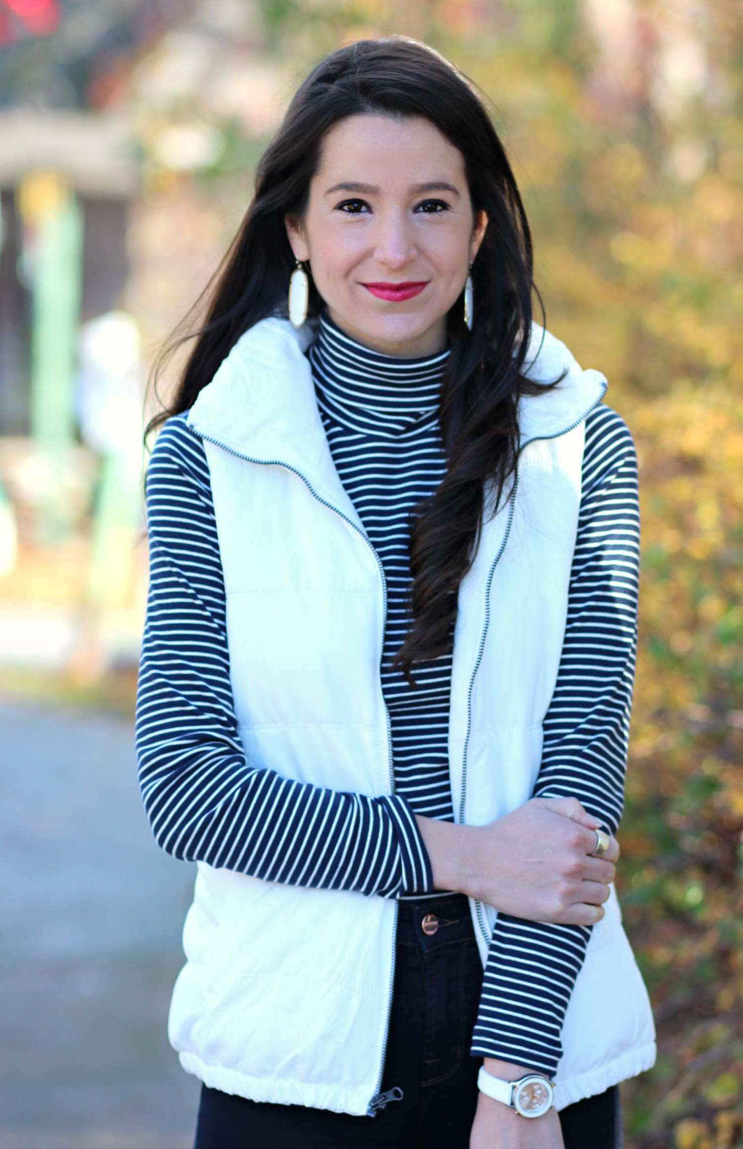 Cute and preppy fall outfit idea with J Brand dark wash flare jeans, Old Navy white puffer vest, and LL Bean striped turtleneck