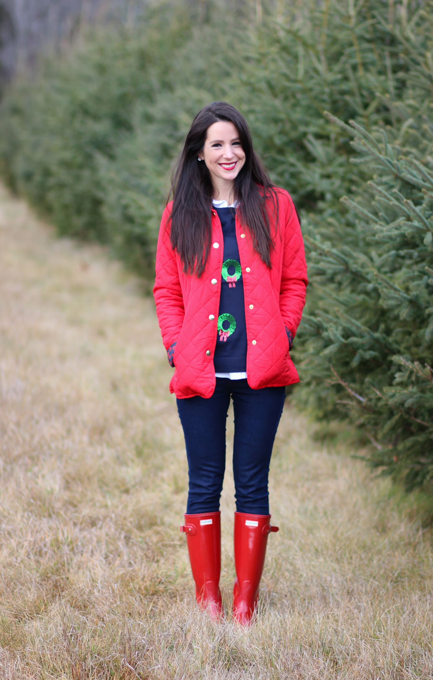 Cutting down our Christmas tree in the perfect affordable quilted red jacket from Crown & Ivory
