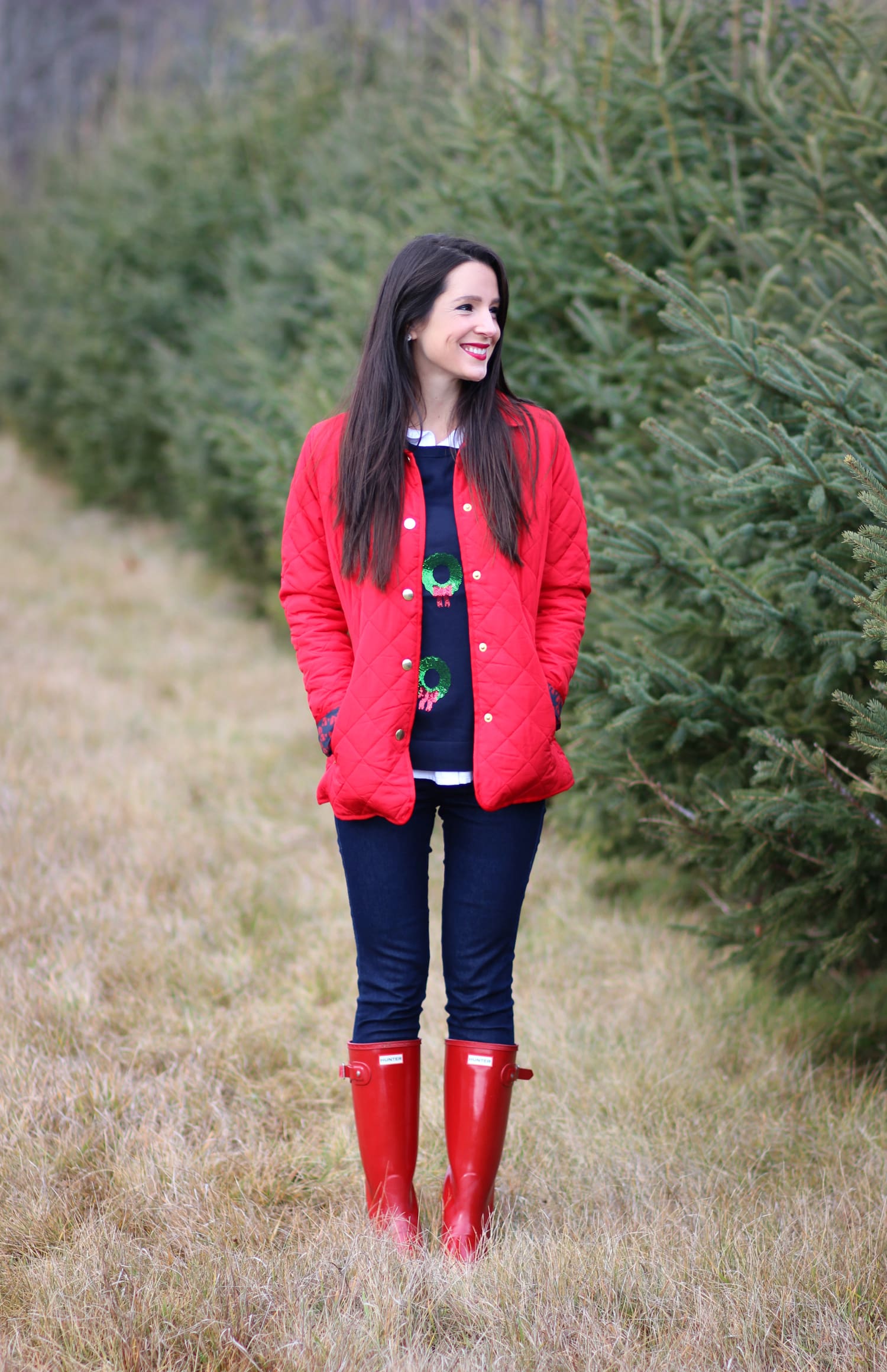 Cutting down our Christmas tree in the perfect affordable quilted red jacket from Crown & Ivory