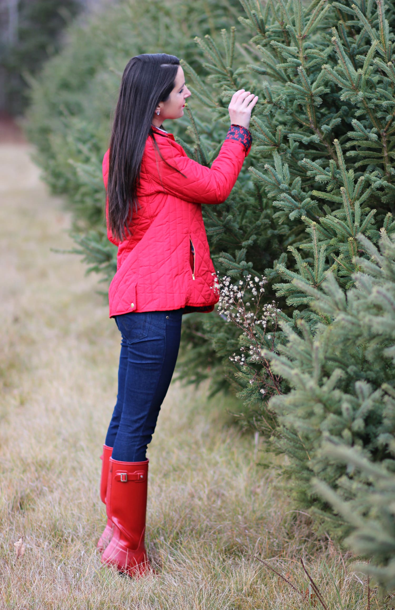 Cutting down our Christmas tree in the perfect affordable quilted red jacket from Crown & Ivory
