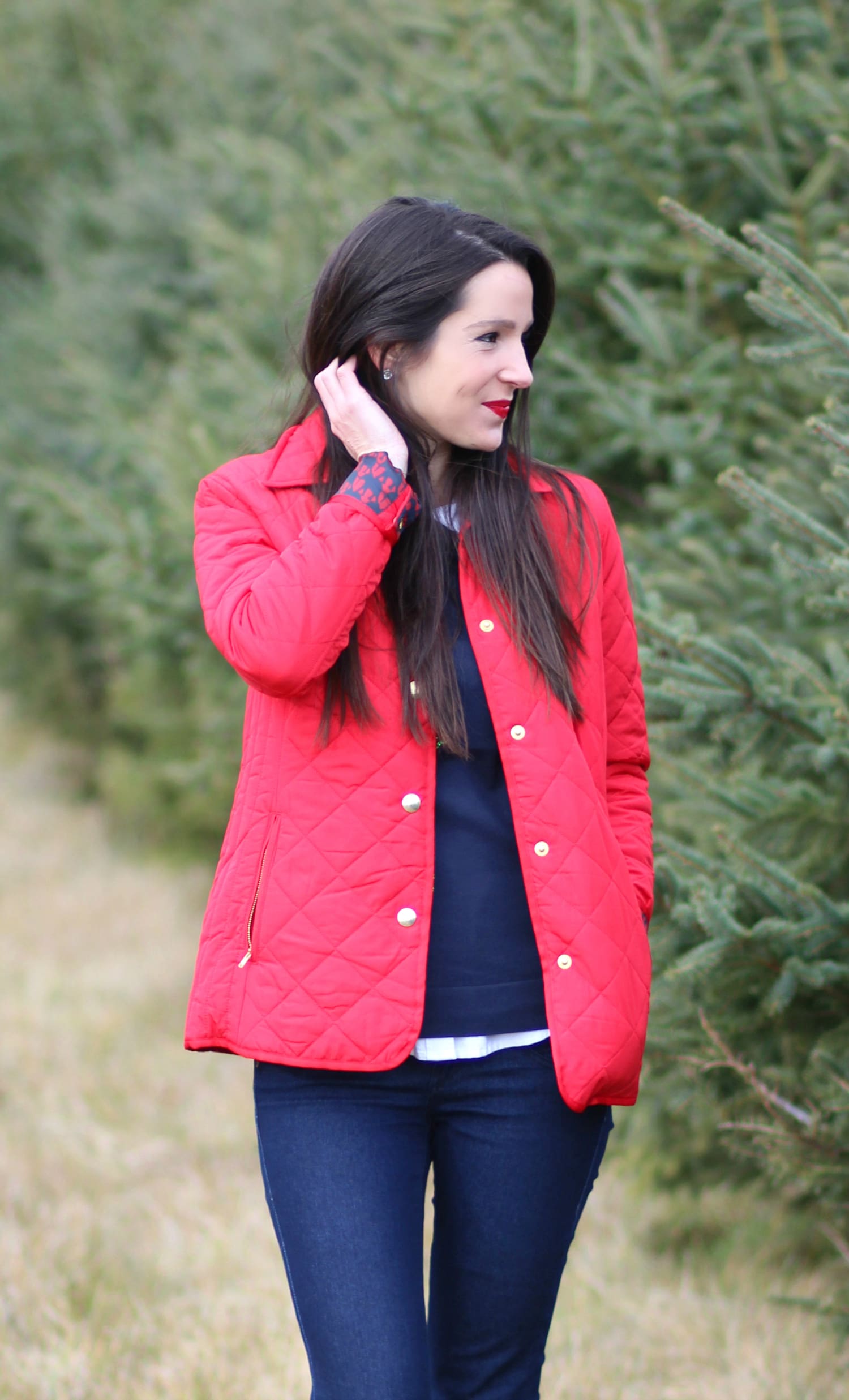 Cutting down our Christmas tree in the perfect affordable quilted red jacket from Crown & Ivory