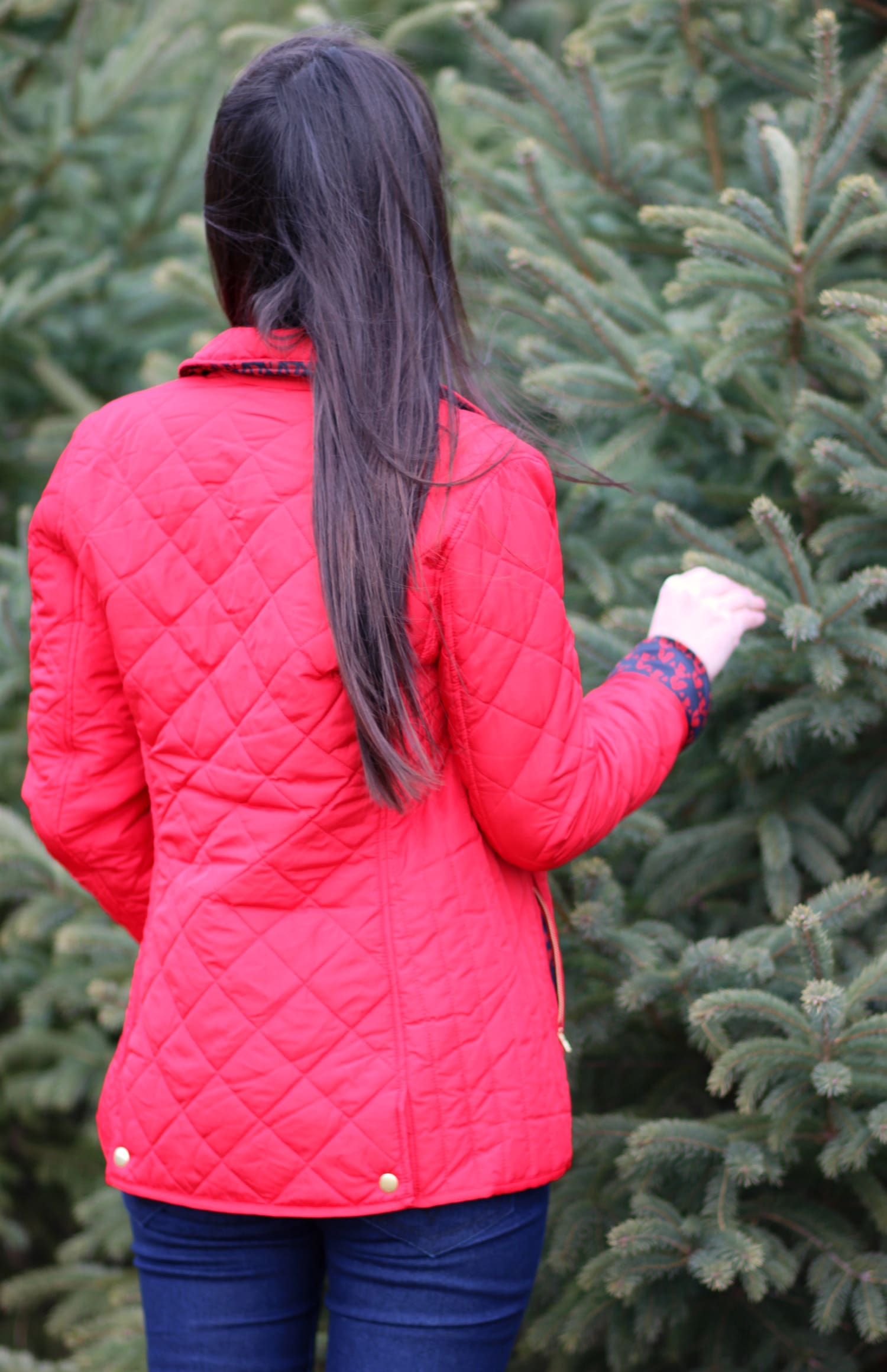 Cutting down our Christmas tree in the perfect affordable quilted red jacket from Crown & Ivory