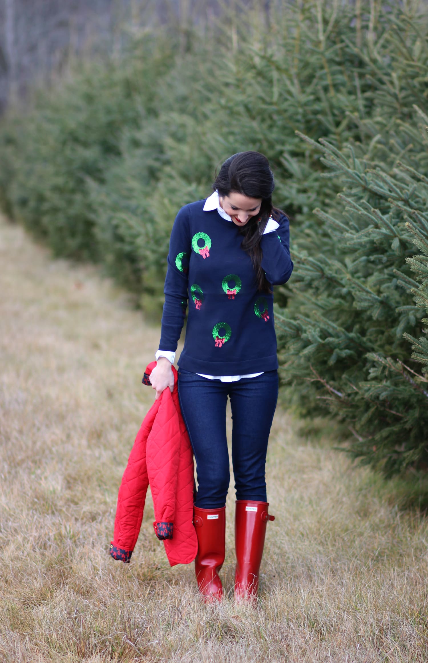 Cutting down our Christmas tree in the perfect affordable quilted red jacket from Crown & Ivory