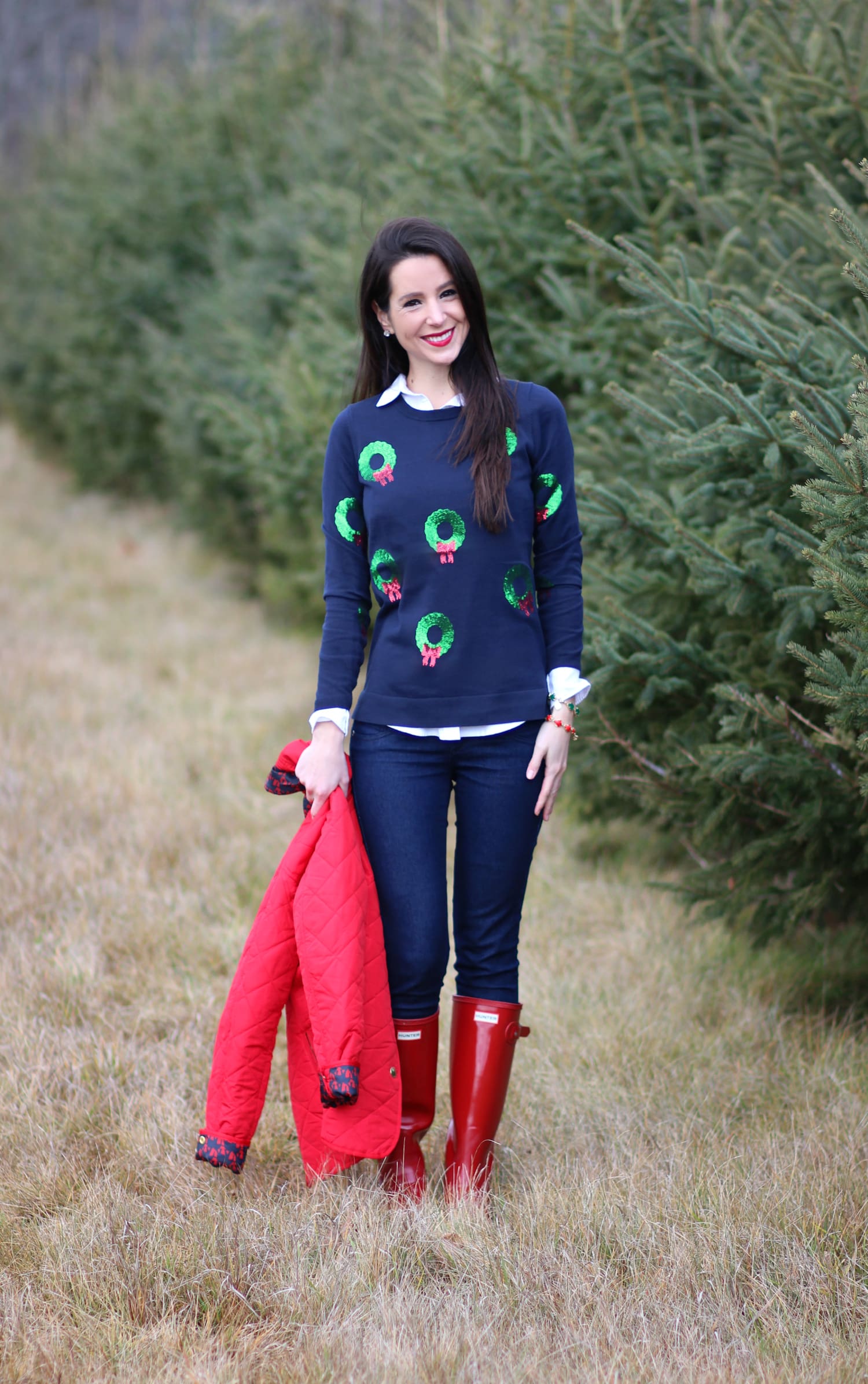 Cutting down our Christmas tree in the perfect affordable quilted red jacket from Crown & Ivory