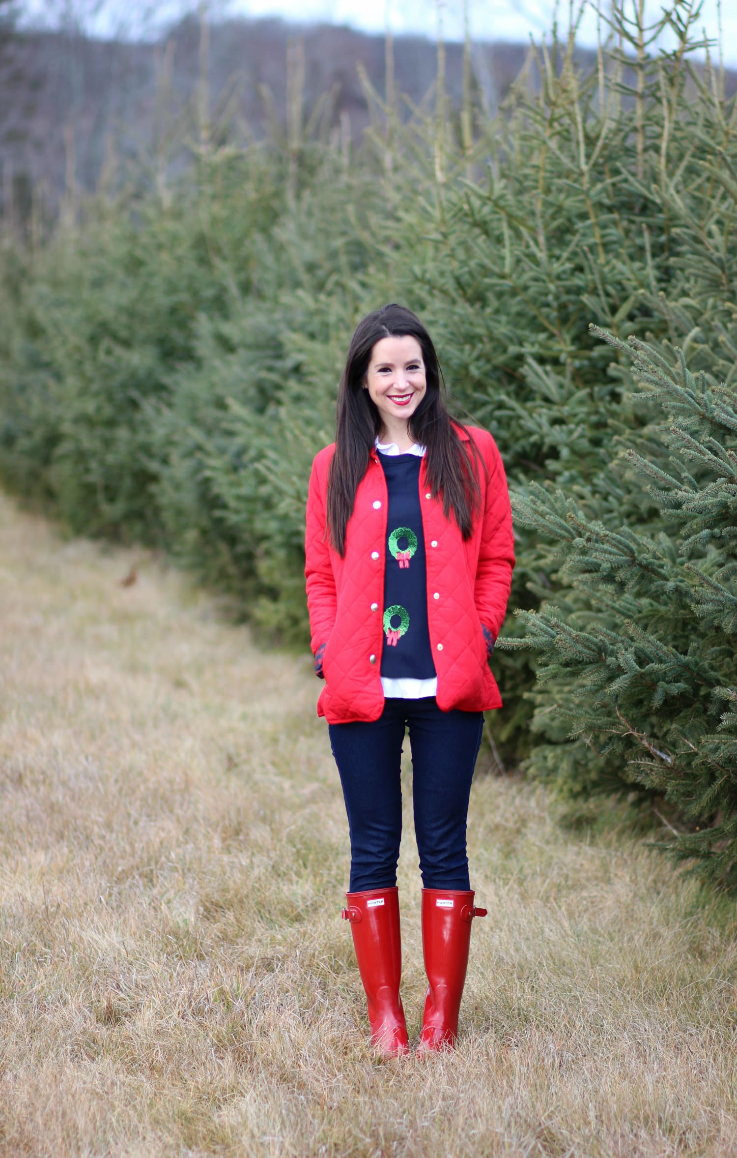 Cutting down our Christmas tree in the perfect affordable quilted red jacket from Crown & Ivory