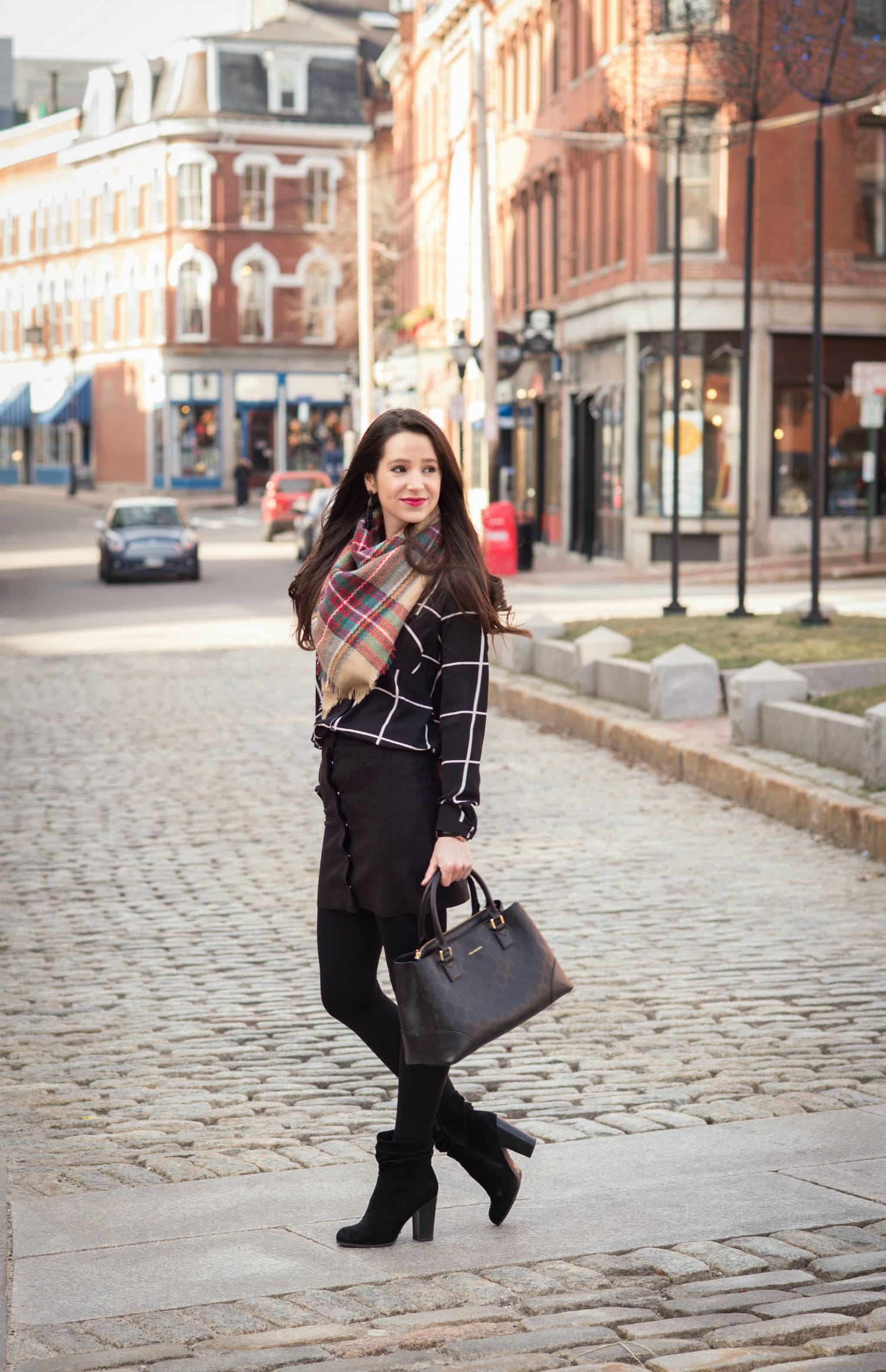 Chic all black winter outfit with a pop of color in the scarf