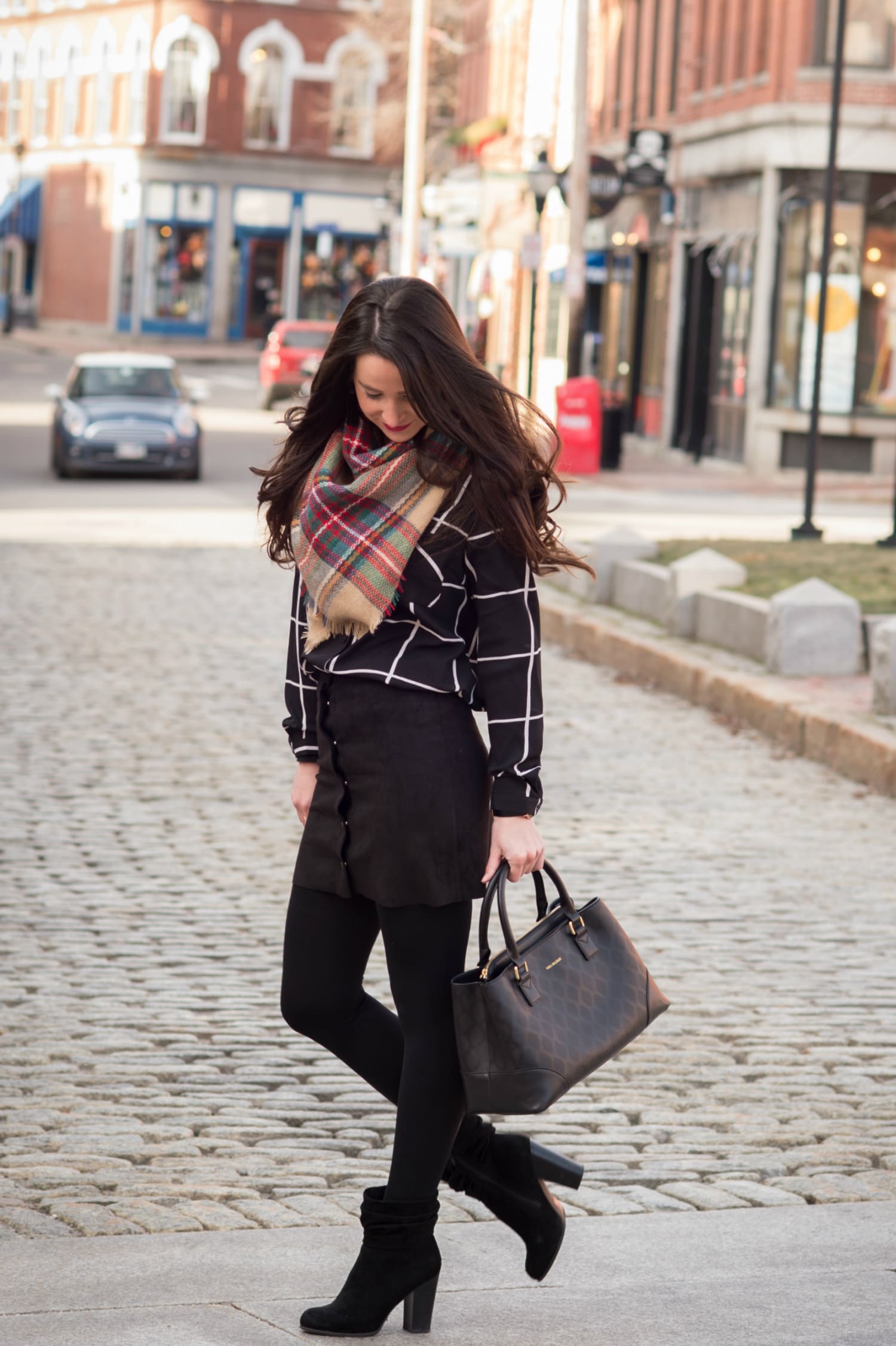 Chic all black winter outfit with a pop of color in the scarf