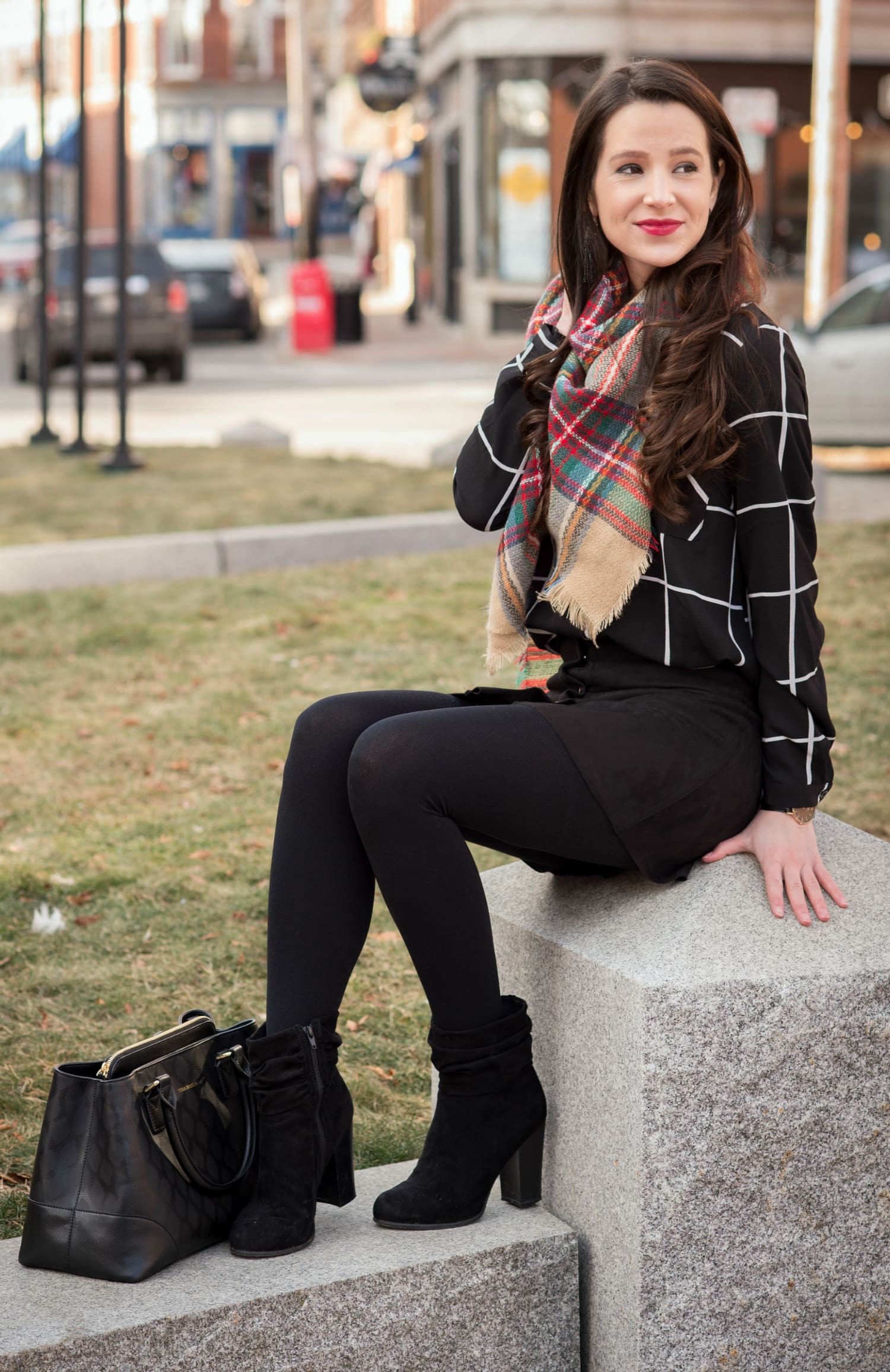 Chic all black winter outfit with a pop of color in the scarf