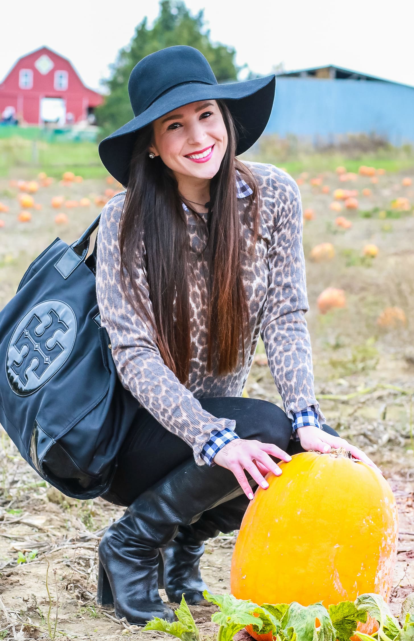 Black floppy hat with leopard crewneck sweater, J.Crew Factory blue gingham button down, black jeans, Nine West tall black boots, and a Tory Burch Ella tote | Comfy and casual fall outfit idea | Floppy hat outfit idea | How to wear a floppy hat in the fall by fashion blogger Stephanie Ziajka from Diary of a Debutante