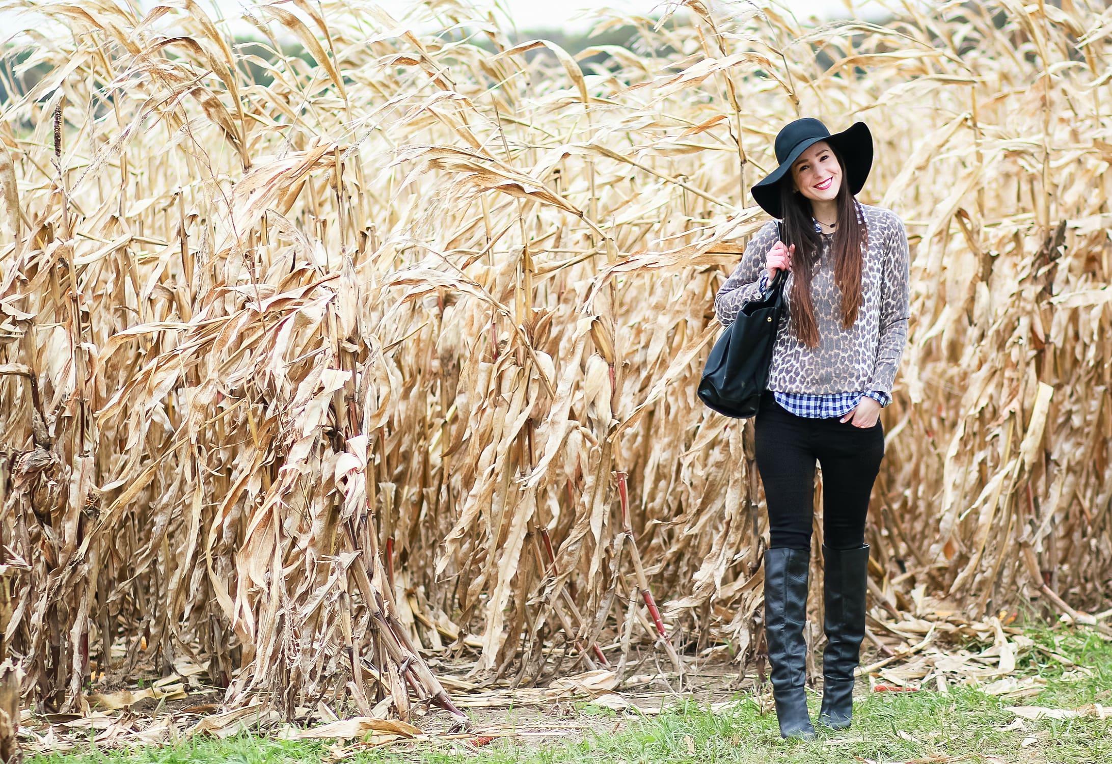 Black floppy hat with leopard crewneck sweater, J.Crew Factory blue gingham button down, black jeans, Nine West tall black boots, and a Tory Burch Ella tote | Comfy and casual fall outfit idea | How to wear a floppy hat in the fall by fashion blogger Stephanie Ziajka from Diary of a Debutante