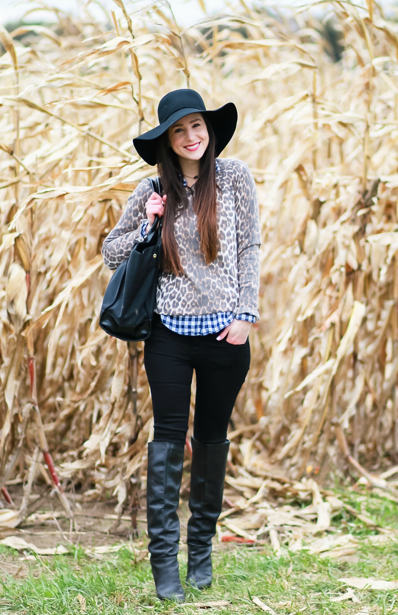 Black floppy hat with leopard crewneck sweater, J.Crew Factory blue gingham button down, black jeans, Nine West tall black boots, and a Tory Burch Ella tote | Comfy and casual fall outfit idea | How to wear a floppy hat in the fall by fashion blogger Stephanie Ziajka from Diary of a Debutante