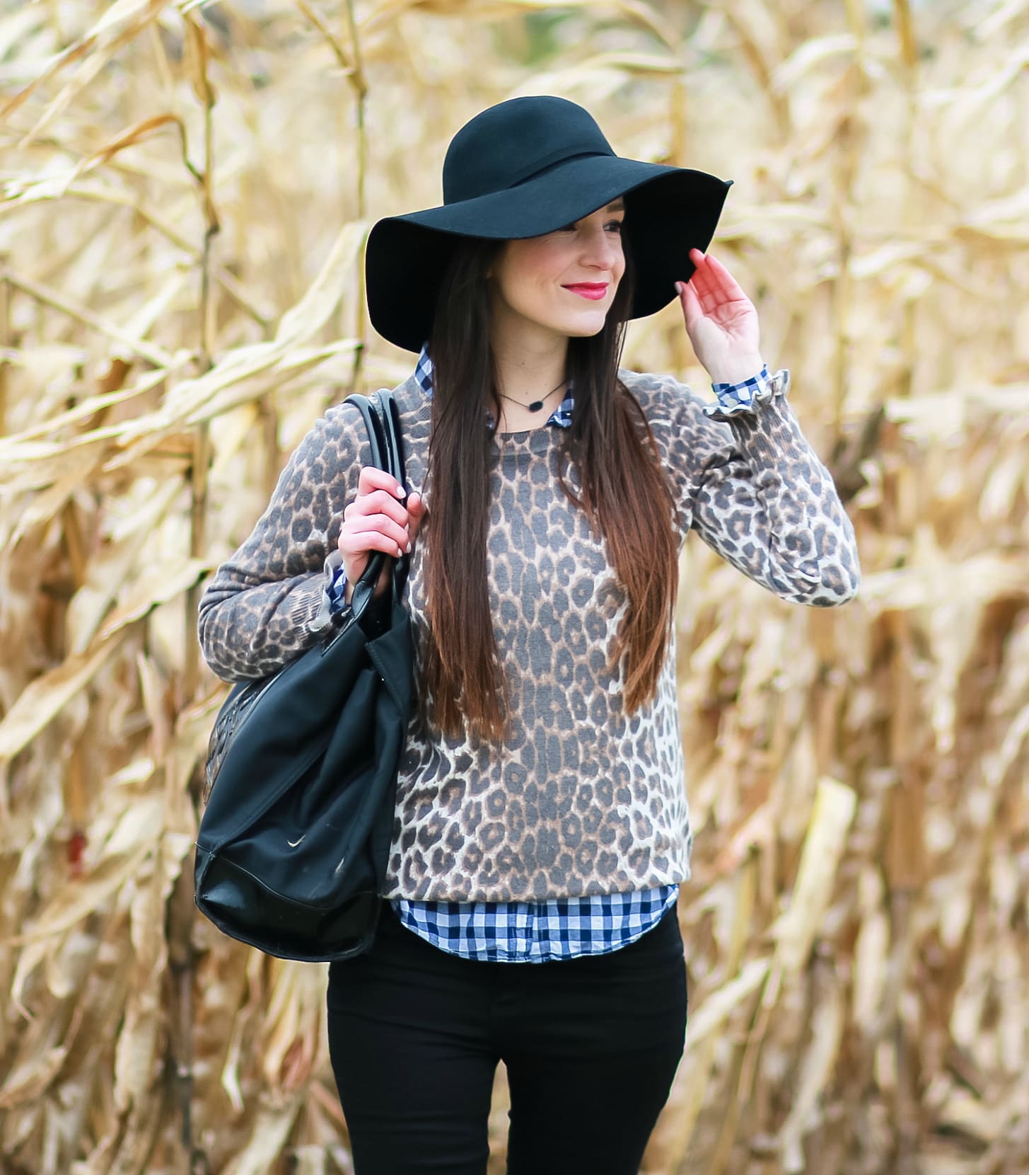 Black floppy hat with leopard crewneck sweater, J.Crew Factory blue gingham button down, black jeans, Nine West tall black boots, and a Tory Burch Ella tote | Comfy and casual fall outfit idea | Floppy hat outfit idea | How to wear a floppy hat in the fall by fashion blogger Stephanie Ziajka from Diary of a Debutante
