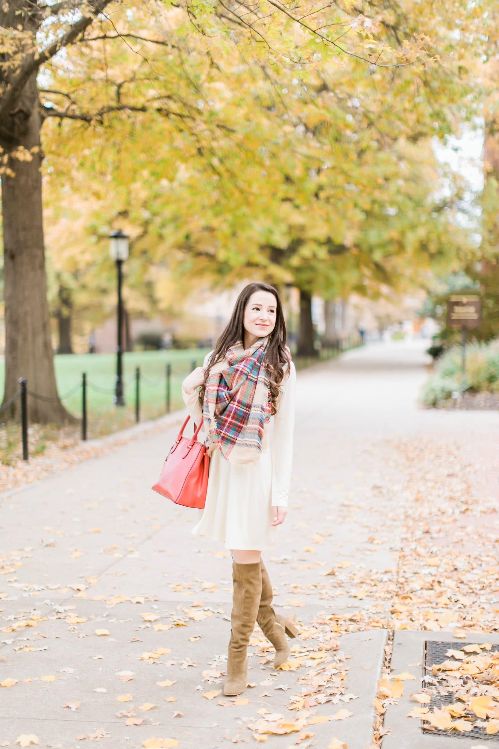 Beige cotton swing dress with tartan blanket scarf, Free People cognac OTK boots, red Ralph Lauren handbag, and Kendra Scott Sophee earrings | Casual holiday outfit idea | 10 tips for looking your best on camera | Tips for Looking Your Best in Holiday Photos from fashion blogger Stephanie Ziajka of Diary of a Debutante