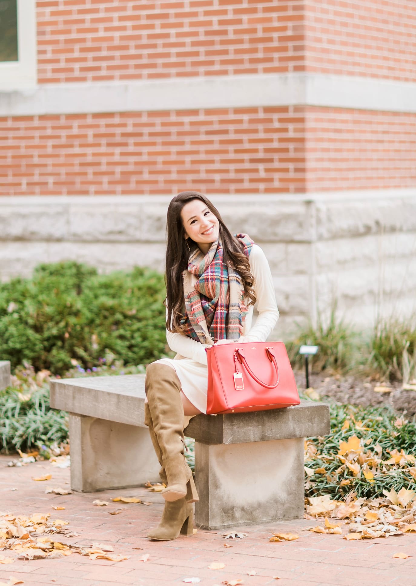 Beige cotton swing dress with tartan blanket scarf, Free People cognac OTK boots, red Ralph Lauren handbag, and Kendra Scott Sophee earrings | Casual holiday outfit idea | 10 tips for looking your best on camera | Tips for Looking Your Best in Holiday Photos from fashion blogger Stephanie Ziajka of Diary of a Debutante