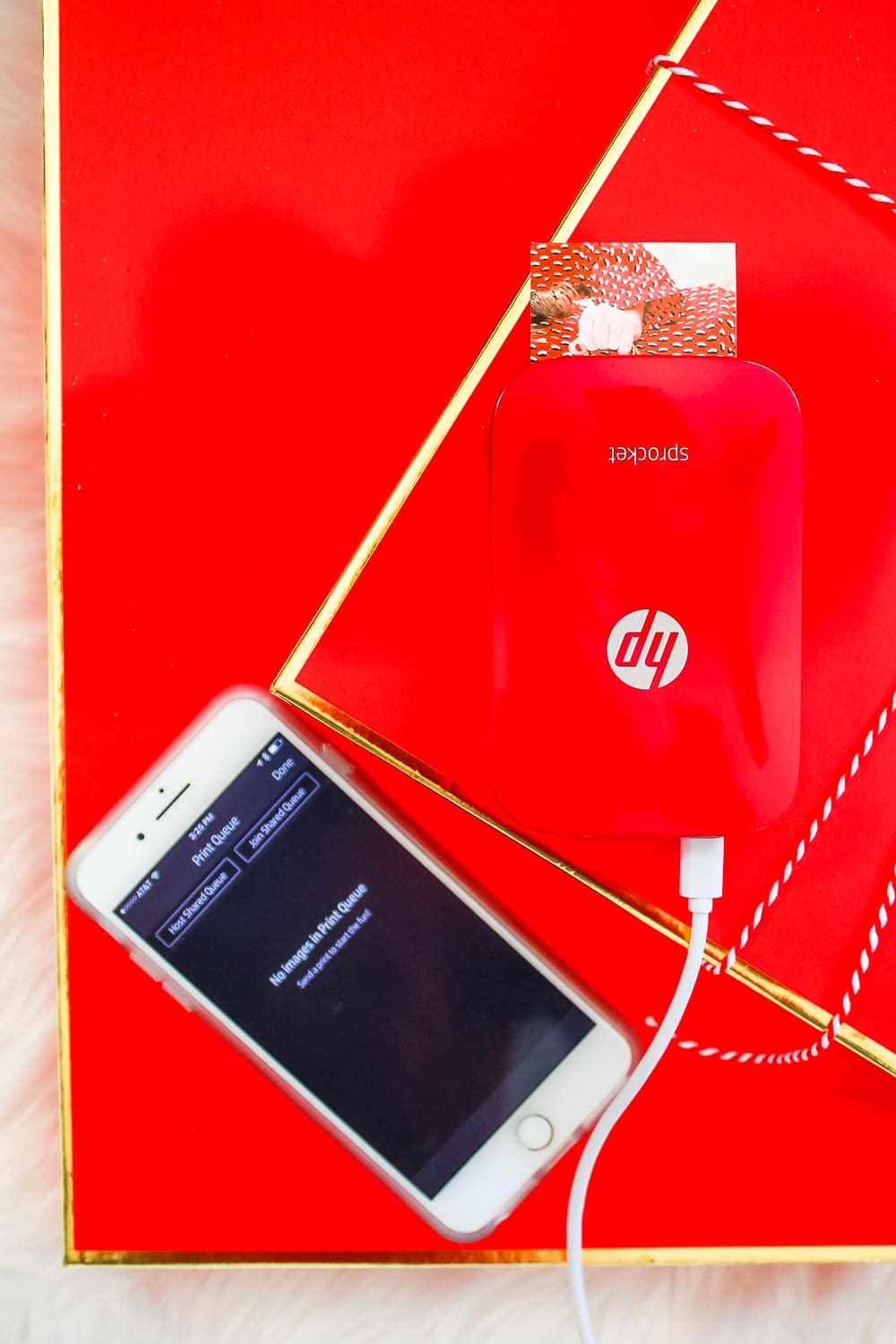 Red HP Sprocket Photo Printer, which makes a perfect stocking stuffer and is the best instant photo printer for events and travel by southern blogger Stephanie Ziajka from Diary of a Debutante