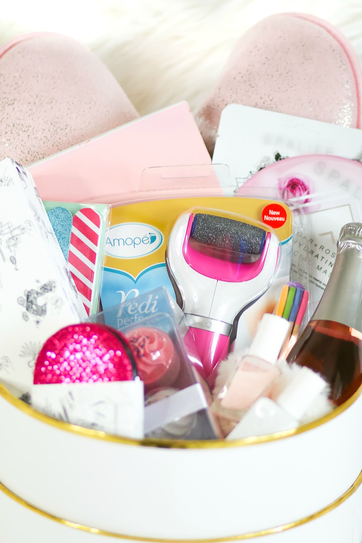 DIY spa gift basket consisting of 12 self care gift ideas she's guaranteed to love, including the Amope Pedi Perfect Foot File, by southern blogger Stephanie Ziajka from Diary of a Debutante