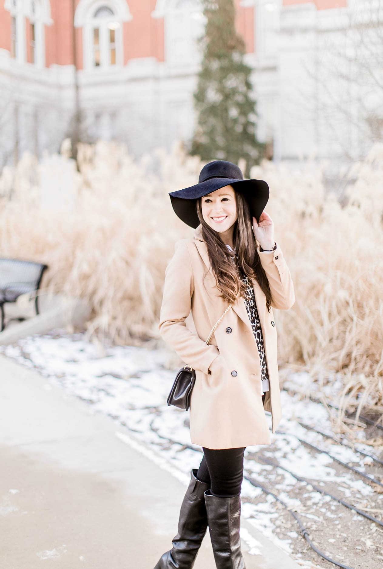 Affordable camel coat from Shein worn with black Mott and Bow skinny jeans, J.Crew Factory leopard crewneck sweater, J.Crew Factory white oxford, Sakkas black wool floppy hat, Nine West black tall boots, and Rebecca Minkoff Love Crossbody purse styled by fashion blogger Stephanie Ziajka from Diary of a Debutante