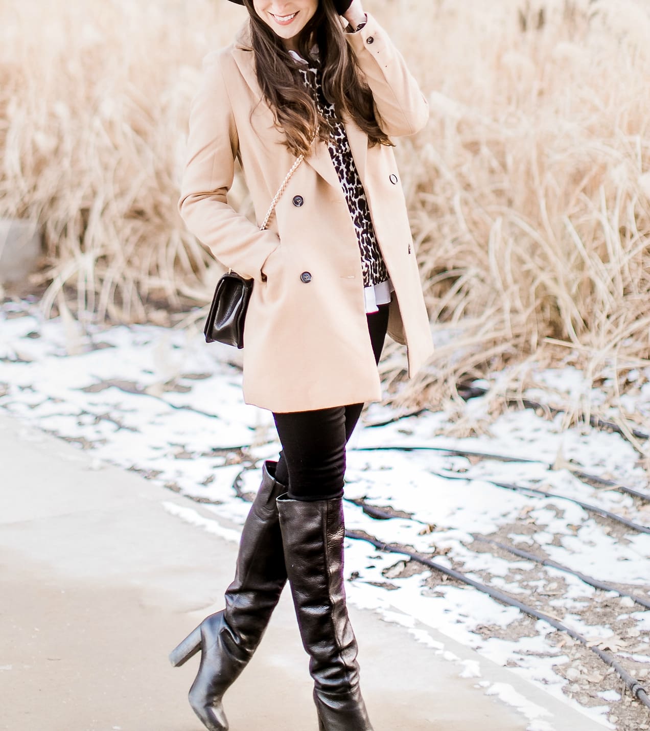 Affordable camel coat from Shein worn with black Mott and Bow skinny jeans, J.Crew Factory leopard crewneck sweater, J.Crew Factory white oxford, Sakkas black wool floppy hat, Nine West black tall boots, and Rebecca Minkoff Love Crossbody purse styled by fashion blogger Stephanie Ziajka from Diary of a Debutante
