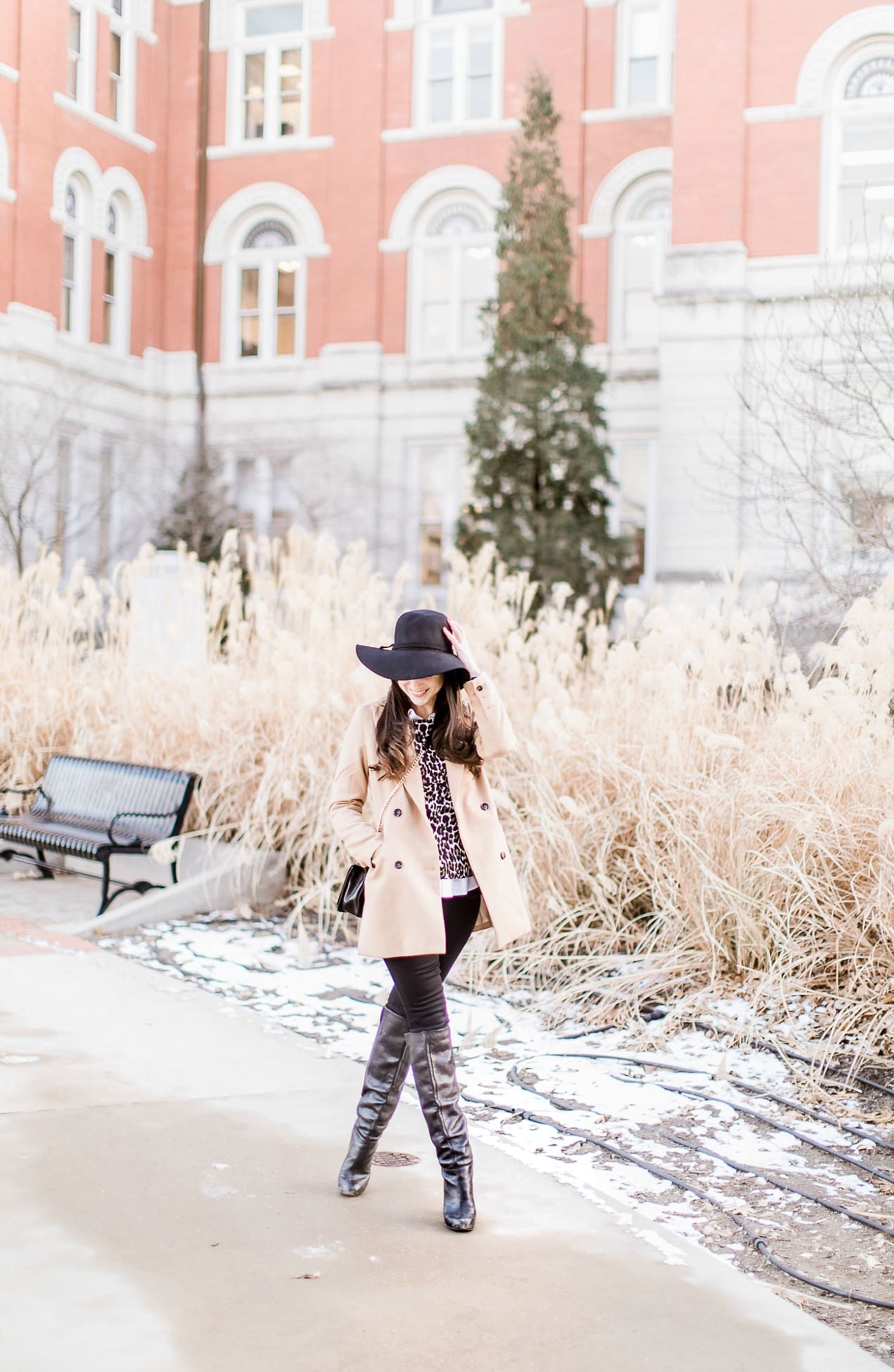 Affordable camel coat from Shein worn with black Mott and Bow skinny jeans, J.Crew Factory leopard crewneck sweater, J.Crew Factory white oxford, Sakkas black wool floppy hat, Nine West black tall boots, and Rebecca Minkoff Love Crossbody purse styled by fashion blogger Stephanie Ziajka from Diary of a Debutante