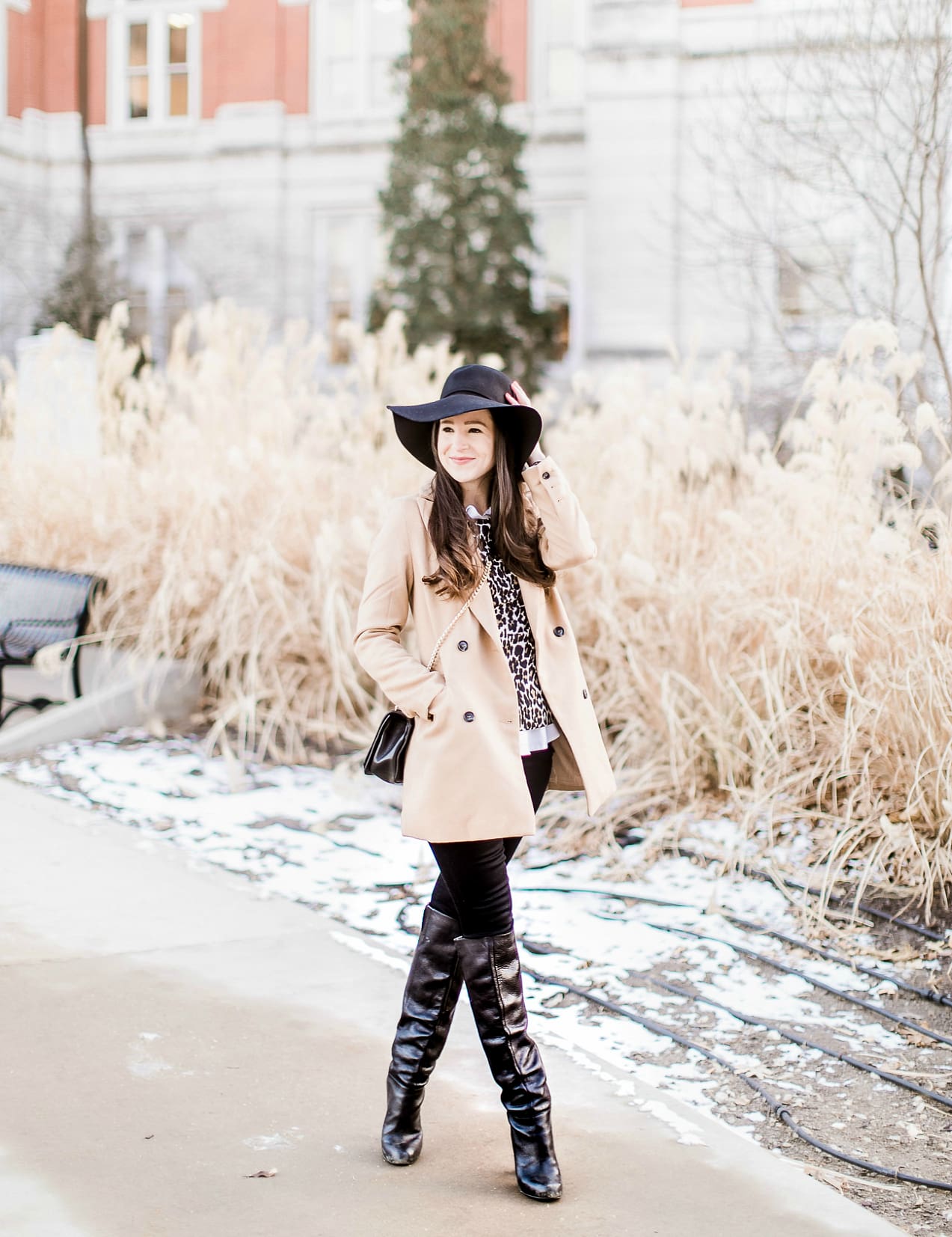 Affordable camel coat from Shein worn with black Mott and Bow skinny jeans, J.Crew Factory leopard crewneck sweater, J.Crew Factory white oxford, Sakkas black wool floppy hat, Nine West black tall boots, and Rebecca Minkoff Love Crossbody purse styled by fashion blogger Stephanie Ziajka from Diary of a Debutante
