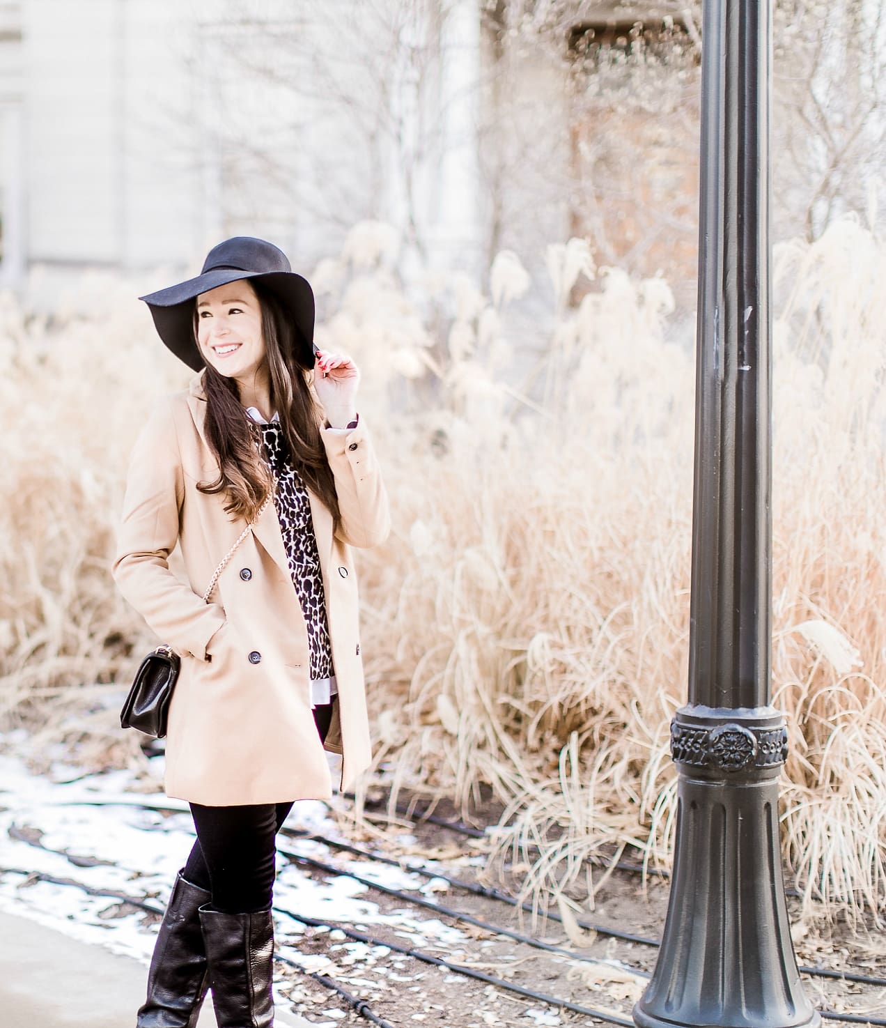 Affordable camel coat from Shein worn with black Mott and Bow skinny jeans, J.Crew Factory leopard crewneck sweater, J.Crew Factory white oxford, Sakkas black wool floppy hat, Nine West black tall boots, and Rebecca Minkoff Love Crossbody purse styled by fashion blogger Stephanie Ziajka from Diary of a Debutante