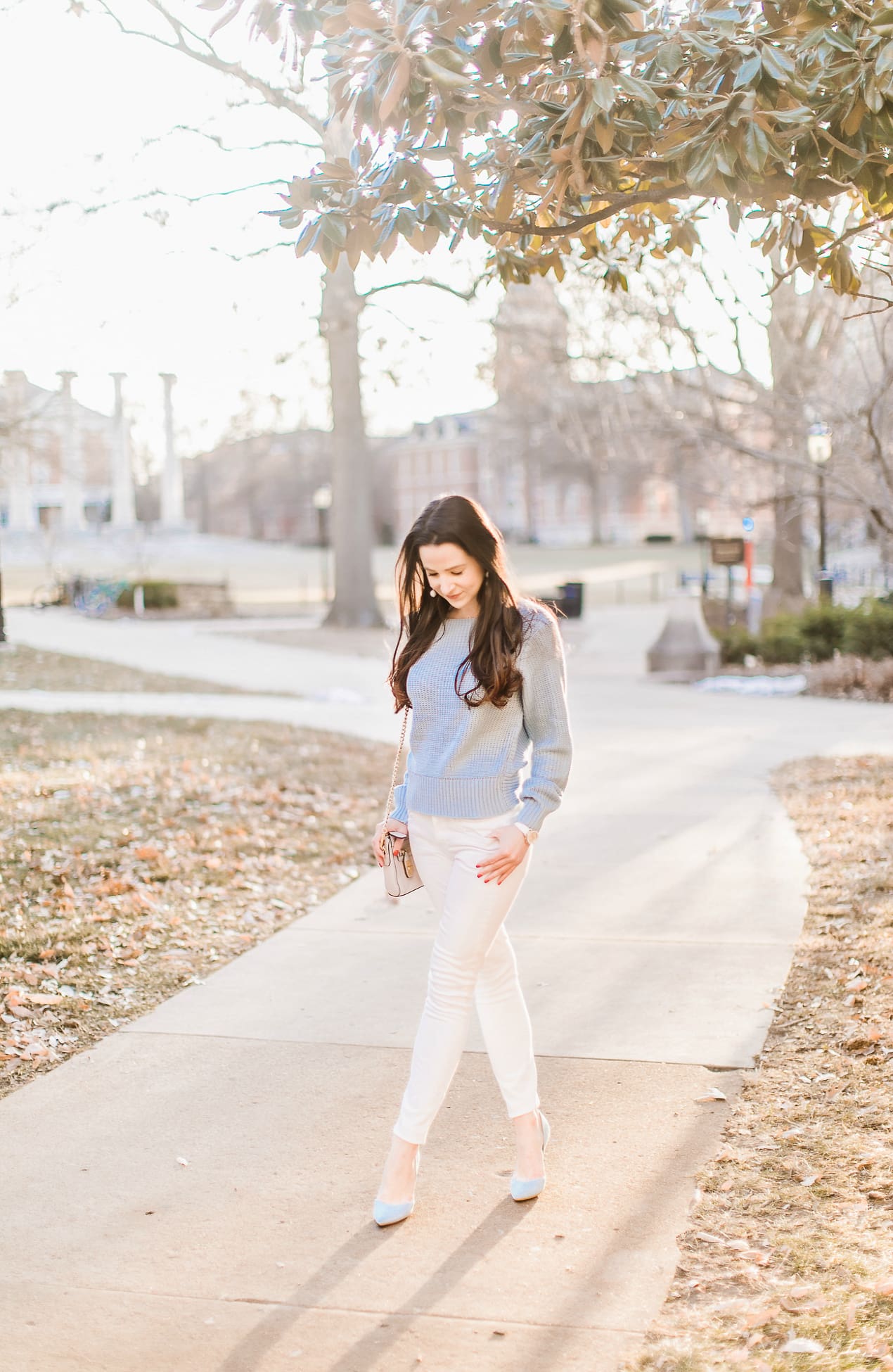 Affordable light blue twist front sweater styled with Express white skinny jeans, Nine West light blue suede heels, Rebecca Minkoff Avery crossbody, white Michele Cape watch, and Sugarfix by Baublebar triad ball drop earrings, How to beat a winter style rut by southern fashion blogger Stephanie Ziajka from Diary of a Debutante, Fashion Photography by Catherine Rhodes Photography