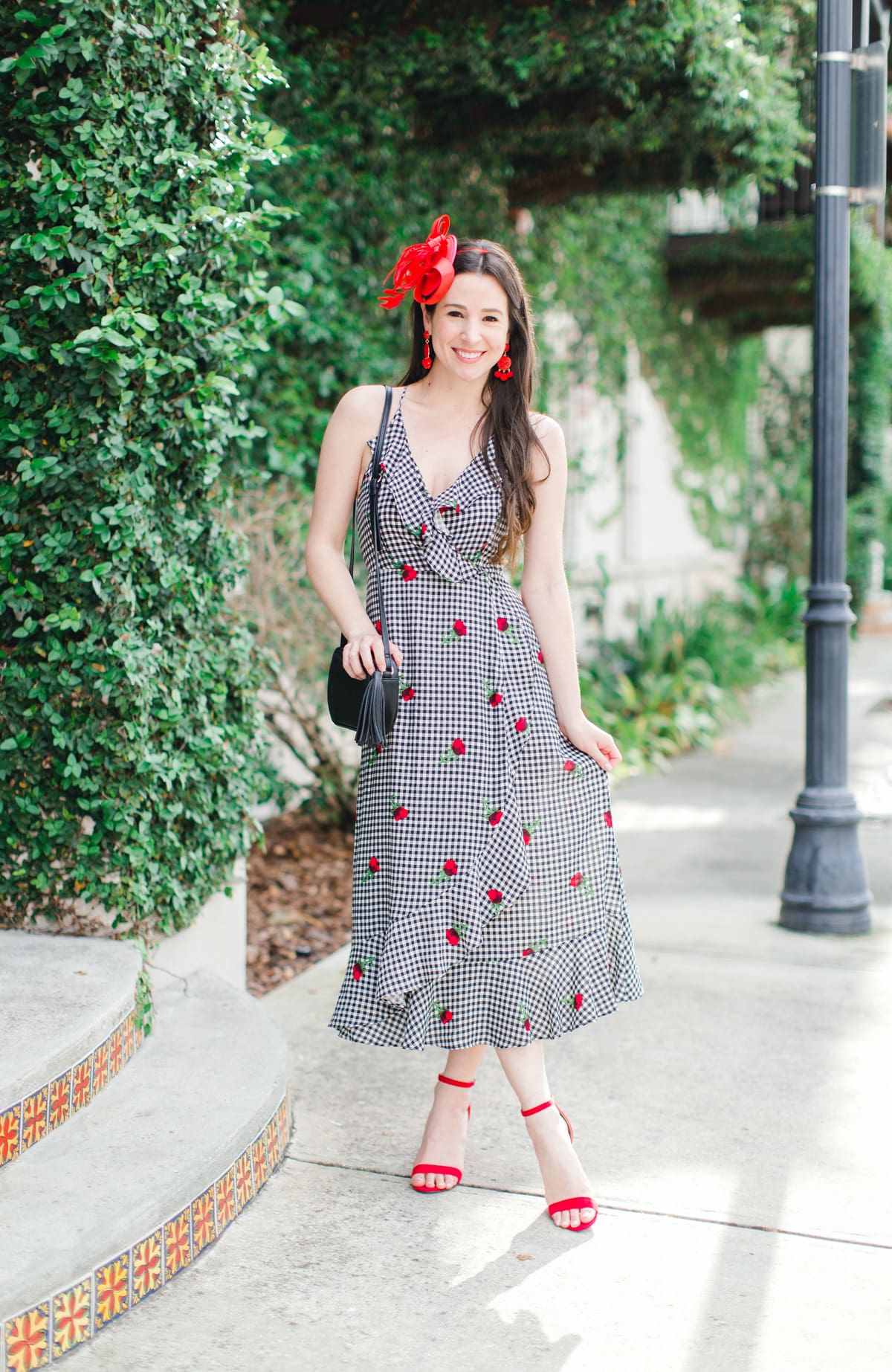 What to Wear on Derby Day: 5 Derby-Approved Outfit Ideas by southern fashion blogger Stephanie Ziajka from Diary of a Debutante, derby day fashion rules, derby day fascinators online, how to wear derby day fascinator, derby day dress code, black and white Kentucky Derby dress with affordable red fascinator, red open toe sandals, red drop bead tassel earrings, and black crossbody bag
