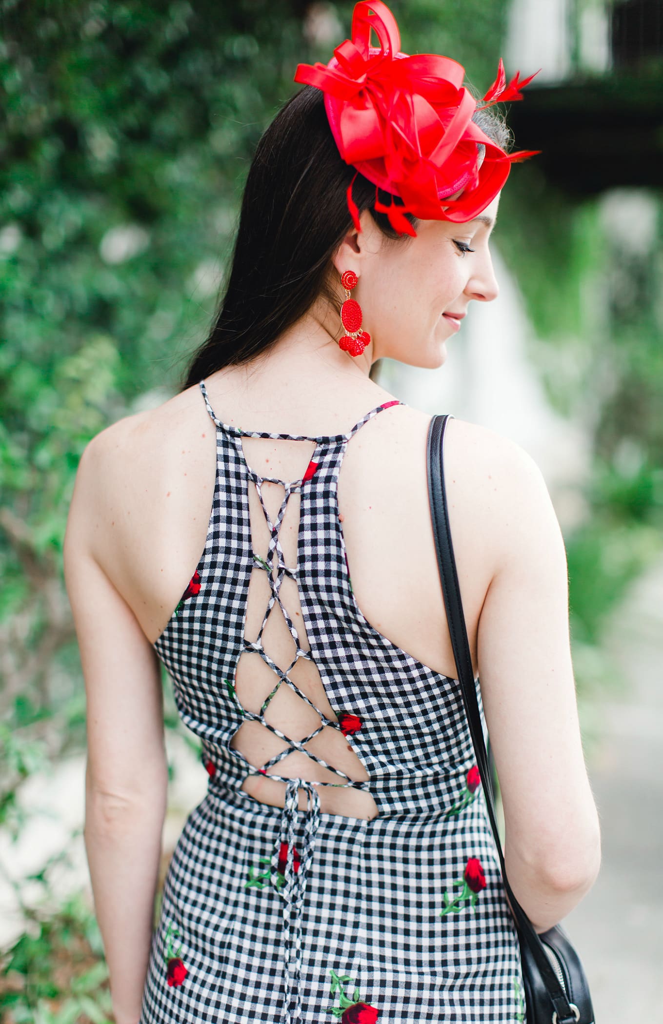 What to Wear on Derby Day: 5 Derby-Approved Outfit Ideas by southern fashion blogger Stephanie Ziajka from Diary of a Debutante, derby day fashion rules, derby day fascinators online, how to wear derby day fascinator, derby day dress code, black and white Kentucky Derby dress with affordable red fascinator, red open toe sandals, red drop bead tassel earrings, and black crossbody bag