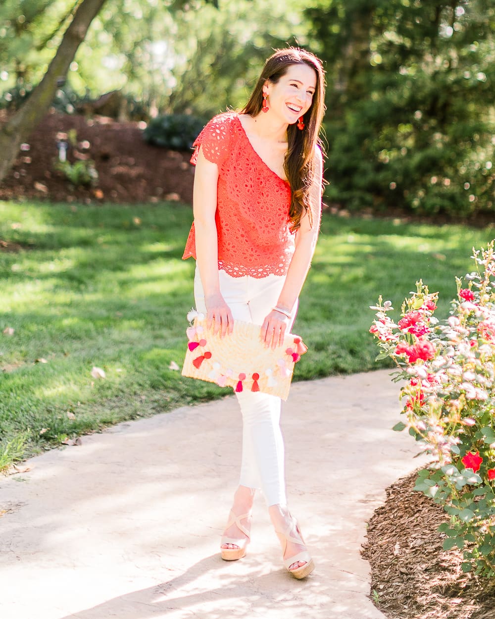 What to wear over Memorial Day Weekend by southern fashion blogger Stephanie Ziajka from Diary of a Debutante, Memorial Day outfit idea, BB Dakota Lolita top styled with white Levi's ankle skinny jeans, Madden nude wedges, Amazon straw tassel clutch, Amazon red beaded earrings, and Kendra Scott Aubrey mixed metals bangle bracelet set