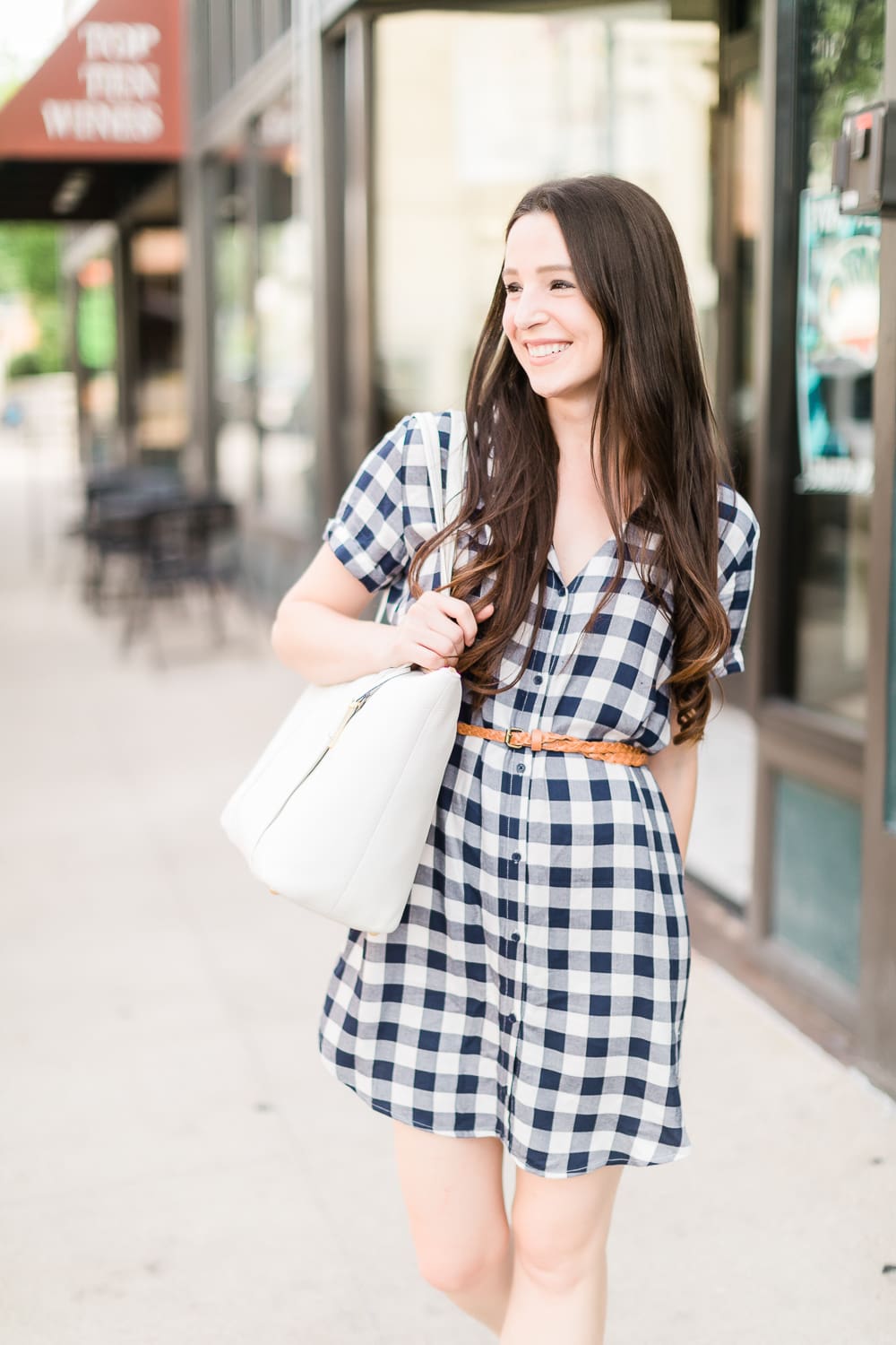 How to wear a plaid shirtdress in the summer by southern fashion blogger Stephanie Ziajka from Diary of a Debutante, how to wear plaid shirtdress, plaid shirt dress outfit, style plaid, BB Dakota Cicely Shirtdress styled with white Jack Rogers sandals, a white Vera Bradley Mallory tote, skinny braided leather belt, and large pearl stud earrings