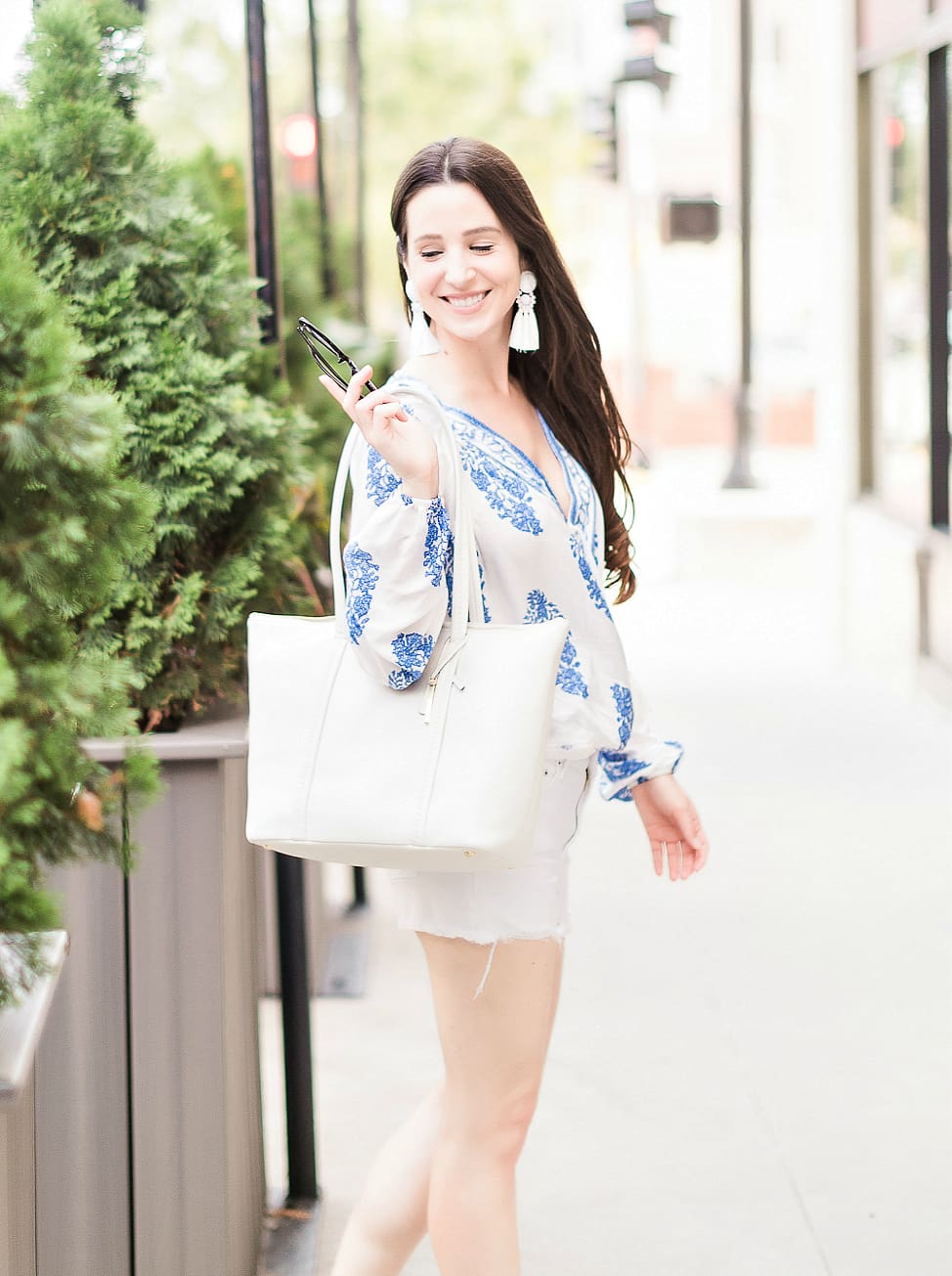 Score or Scam: The Truth about Shein Clothing by affordable fashion blogger Stephanie Ziajka from Diary of a Debutante, Shein quality review, is Shein good quality, porcelain print wrap top styled with white Levi 501 shorts, madden NYC wedges, white Vera Bradley Mallory Tote, white statement tassel earrings, and black Gucci dupe sunglasses