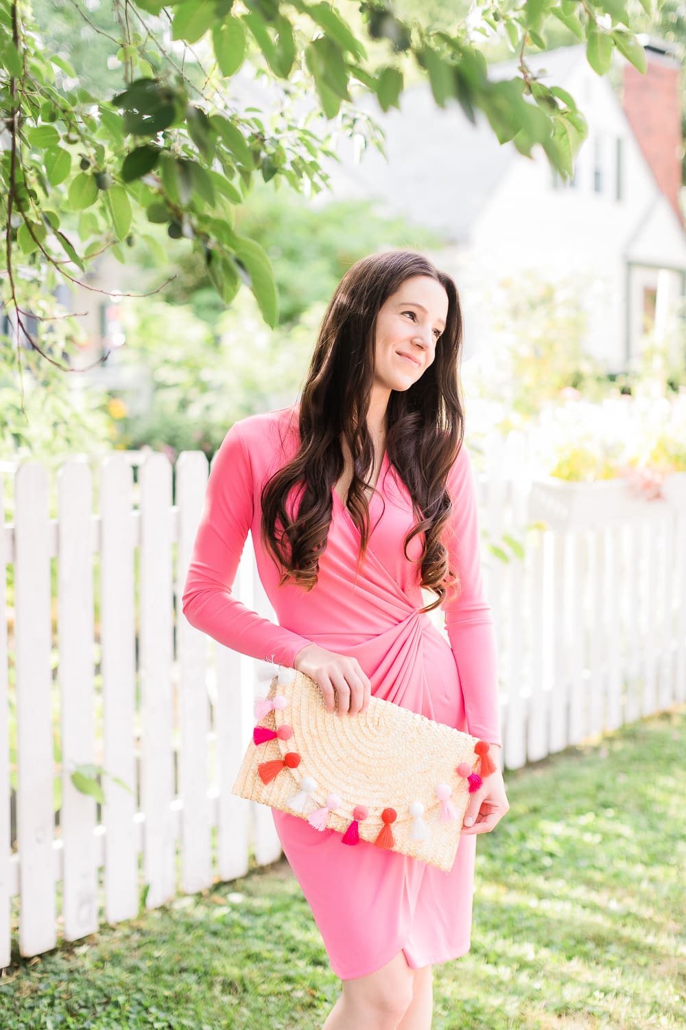 What to wear to a fall baby shower by affordable style blogger Stephanie Ziajka from Diary of a Debutante, what to wear to a baby shower in October, what to wear for gender reveal, how to dress for breast cancer awareness, pink Lark & Ro wrap dress with pink straw tassel clutch and M. Gemi The Cammeo pumps