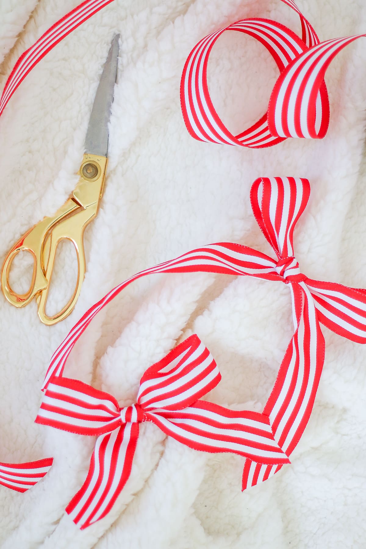 Red and white striped ribbon used to make DIY Christmas gifts by blogger Stephanie Ziajka on Diary of a Debutante