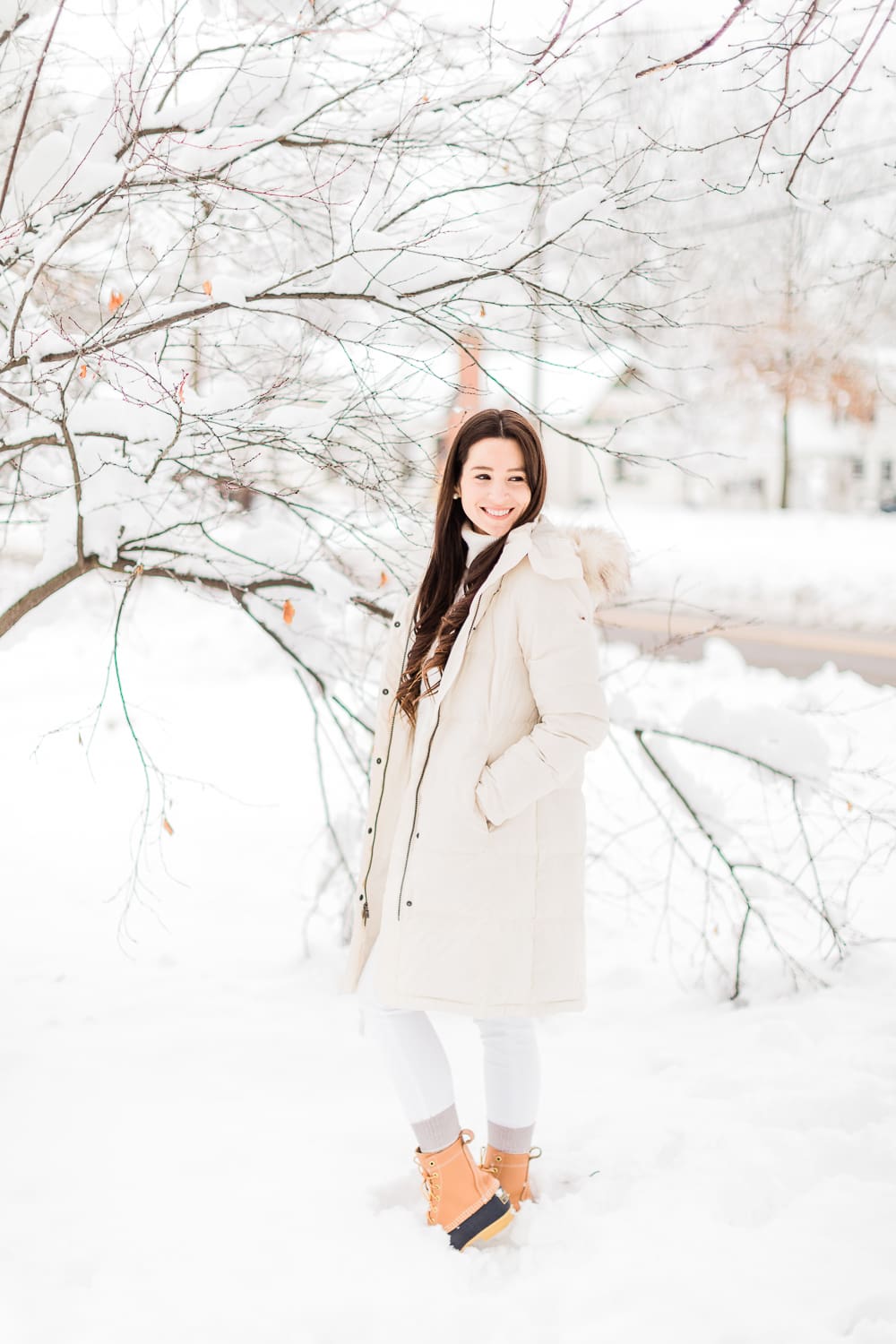 How to Style Bean Boots with the LLBean Ultrawarm Coat by affordable fashion and southern lifestyle blogger Stephanie Ziajka from Diary of a Debutante, LLBean Ultrawarm Coat Three Quarter Length in paperwhite, bean boots style, parka outfit ideas, white sweater outfit, LLBean bean boots styled with LLBean ultrawarm coat, white skinny jeans, and a white oversized turtleneck sweater