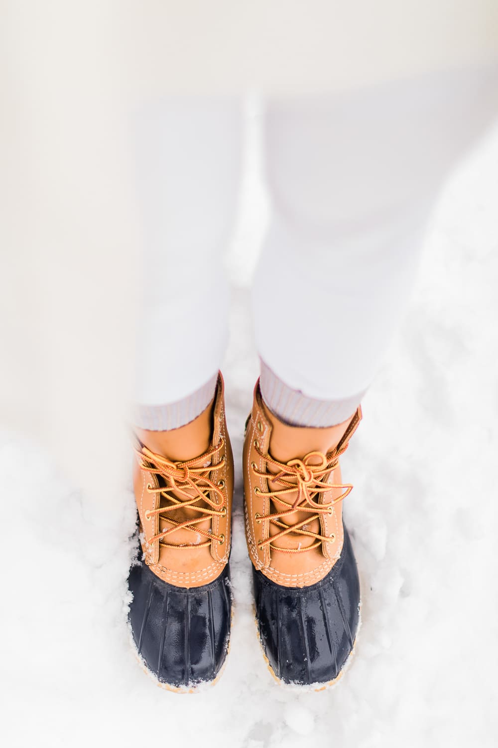 How to Style Bean Boots with the LLBean Ultrawarm Coat by affordable fashion and southern lifestyle blogger Stephanie Ziajka from Diary of a Debutante, LLBean Ultrawarm Coat Three Quarter Length in paperwhite, bean boots style, parka outfit ideas, white sweater outfit, LLBean bean boots styled with LLBean ultrawarm coat, white skinny jeans, and a white oversized turtleneck sweater