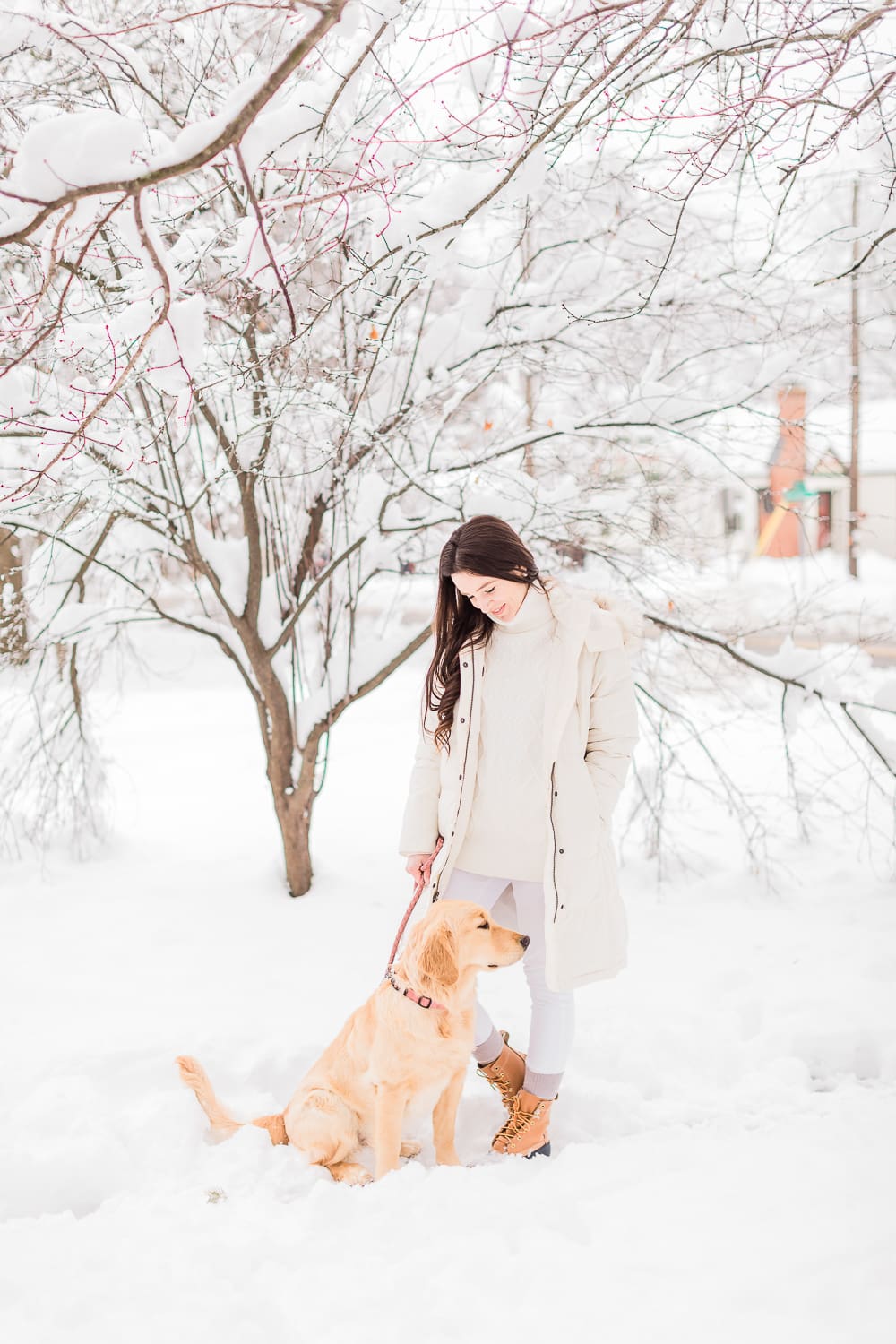 How to Style Bean Boots with the LLBean Ultrawarm Coat by affordable fashion and southern lifestyle blogger Stephanie Ziajka from Diary of a Debutante, LLBean Ultrawarm Coat Three Quarter Length in paperwhite, bean boots style, parka outfit ideas, white sweater outfit, LLBean bean boots styled with LLBean ultrawarm coat, white skinny jeans, and a white oversized turtleneck sweater, golden retriever puppy in the snow