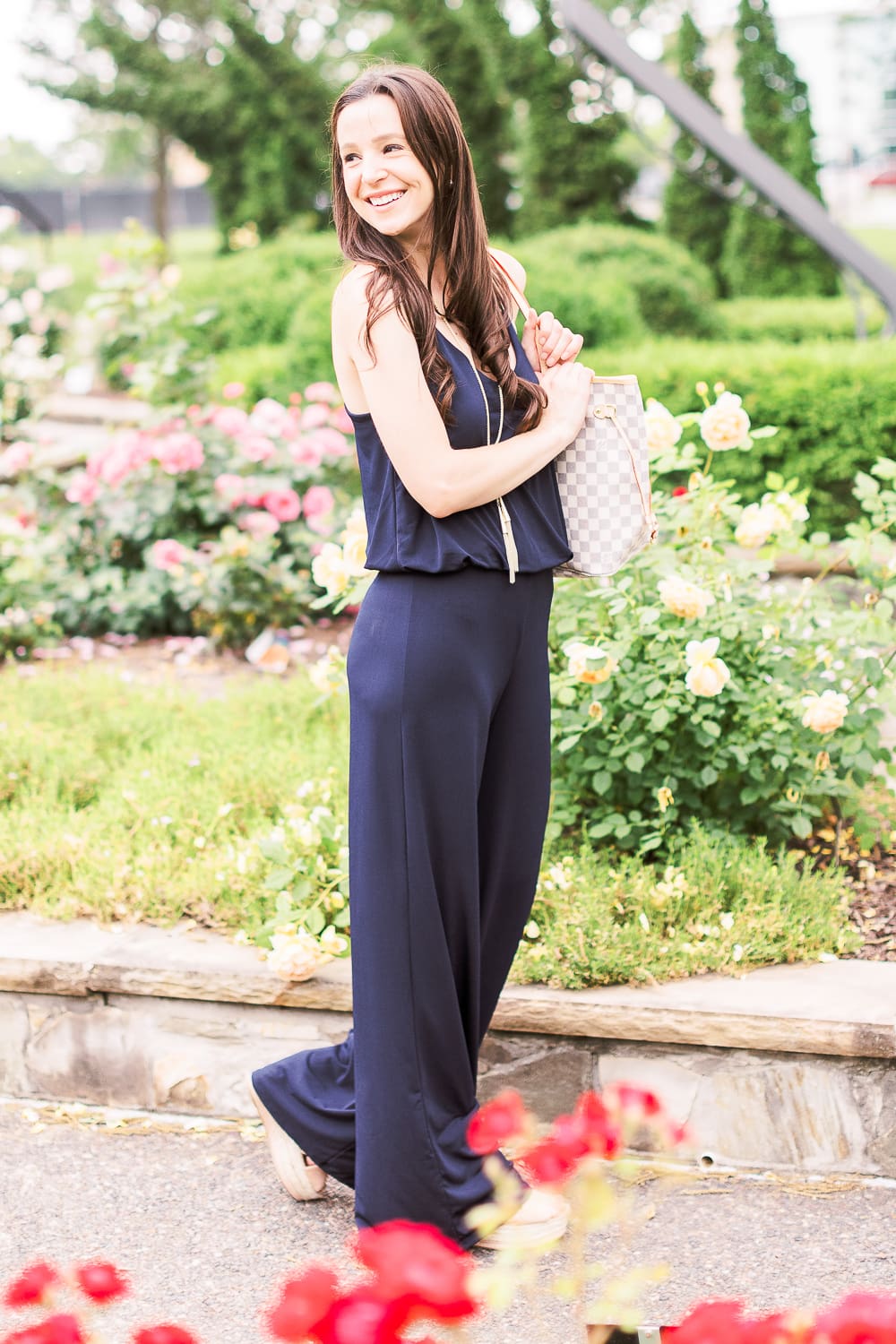 Summer Style Guide: How to Wear a Jumpsuit Casually by popular affordable fashion blogger Stephanie Ziajka from Diary of a Debutante, how to style navy jumpsuit, best shoes to wear with a jumpsuit, navy URBAN K Women's Racerback Jumpsuit, Louis Vuitton Neverfull Dupe Bag, Kendra Scott Phara Necklace