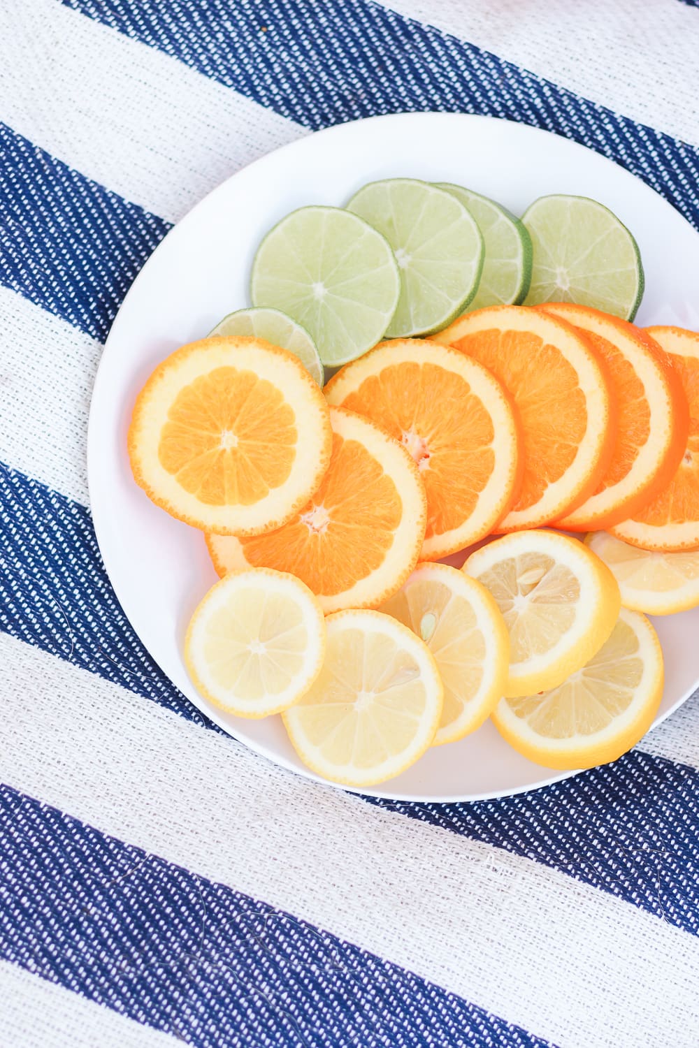 citrus slices at a tea party picnic, orange slices lime slices, lemon slices, citrus in tea