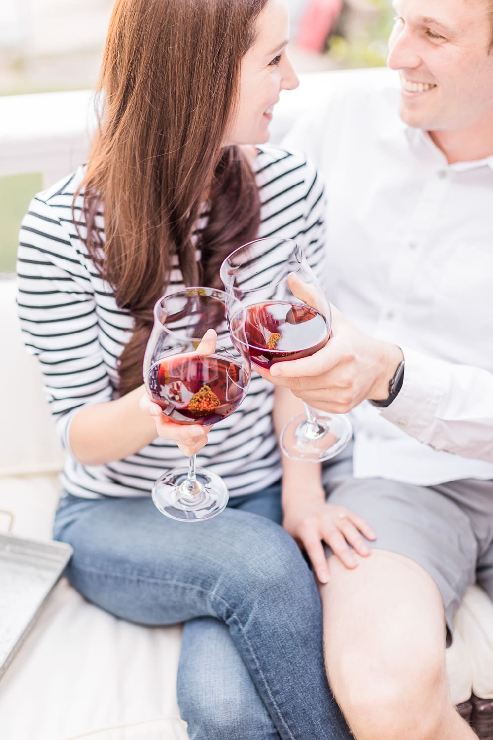 couple drinking red wine on the popular affordable entertaining blog Diary of a Debutante, Yealands Pinot Noir wine, cheers