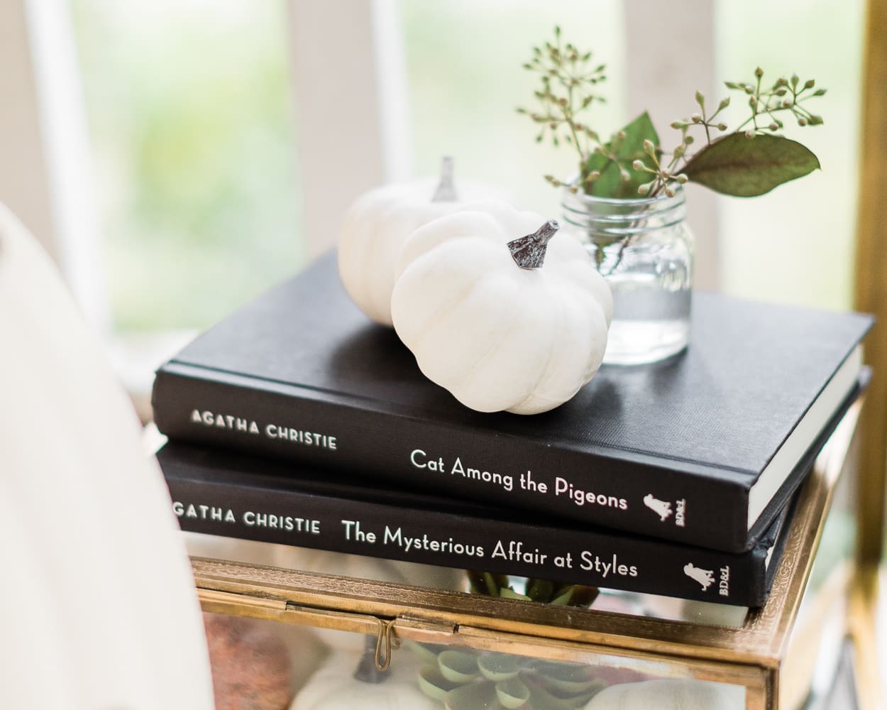 Agatha Christie books on a Halloween bar cart, Halloween Bar Cart + DIY Pumpkin Ice Bucket Tutorial by popular affordable fashion blogger Stephanie Ziajka on Diary of a Debutante, Halloween bar cart ideas, how to decorate a halloween bar cart