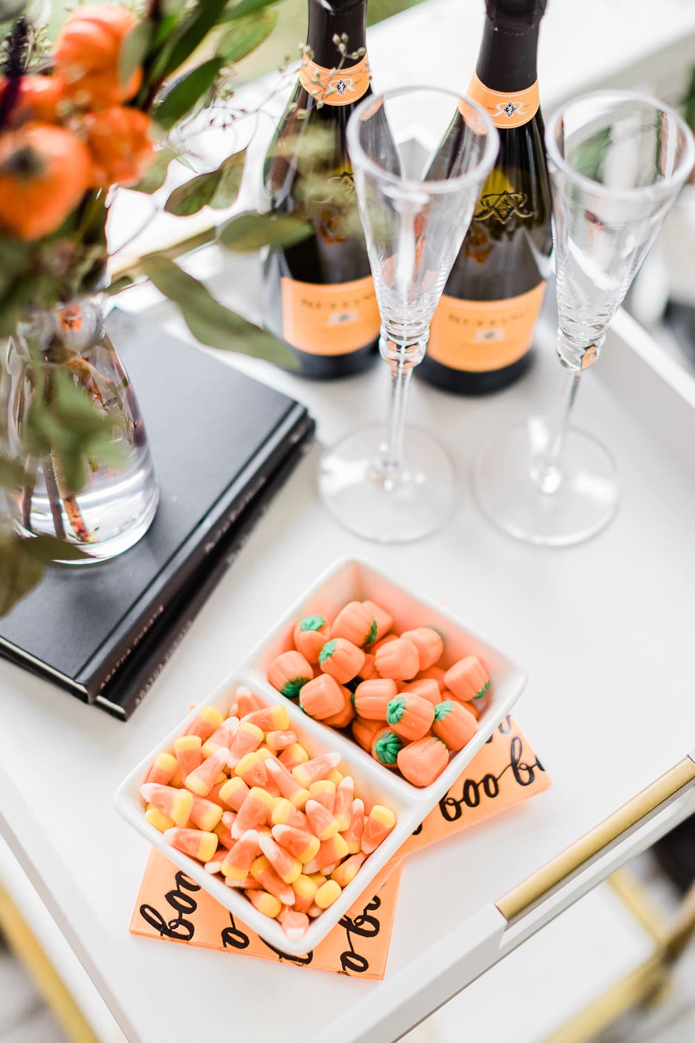 candy corn on a Halloween bar cart, Halloween Bar Cart + DIY Pumpkin Ice Bucket Tutorial by popular affordable fashion blogger Stephanie Ziajka on Diary of a Debutante, Halloween bar cart ideas, how to decorate a halloween bar cart