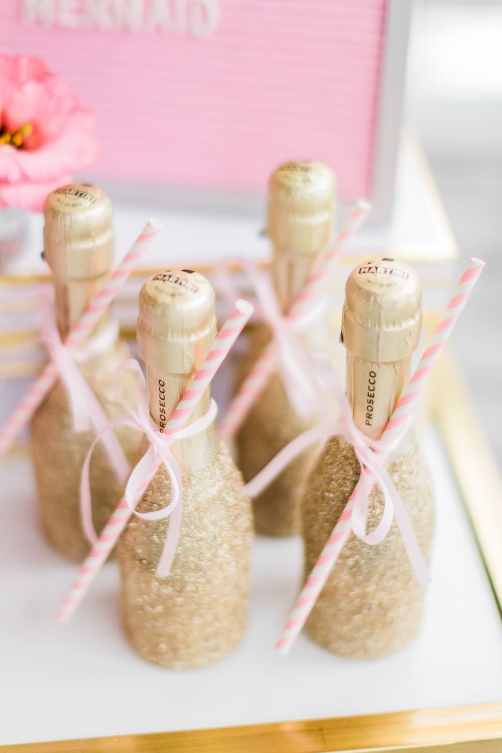Blogger Stephanie Ziajka shares a gold glitter bottles DIY on Diary of a Debutante