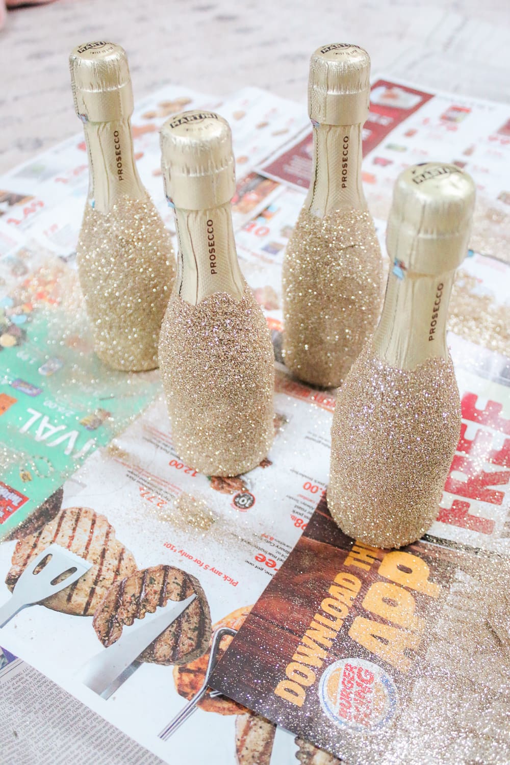 Southern lifestyle blogger Stephanie Ziajka shows how to decorate mini champagne bottles with glitter on Diary of a Debutante