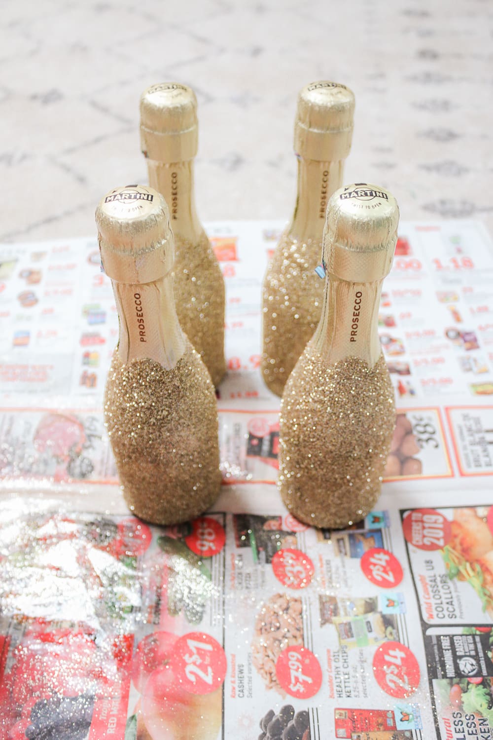 Southern lifestyle blogger Stephanie Ziajka shows how to make mini gold glitter champagne bottles on Diary of a Debutante