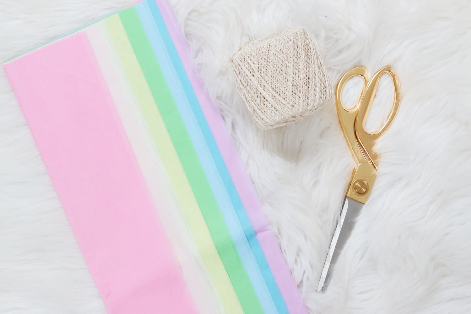 What you need to make tissue garland, including tissue paper, neutral string, and scissors