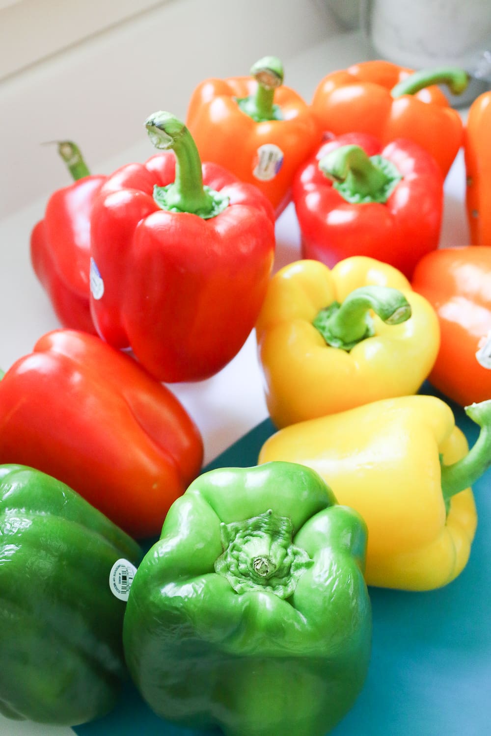 Fresh red, yellow, orange, and green bell peppers to be used for skewering on Diary of a Debutante