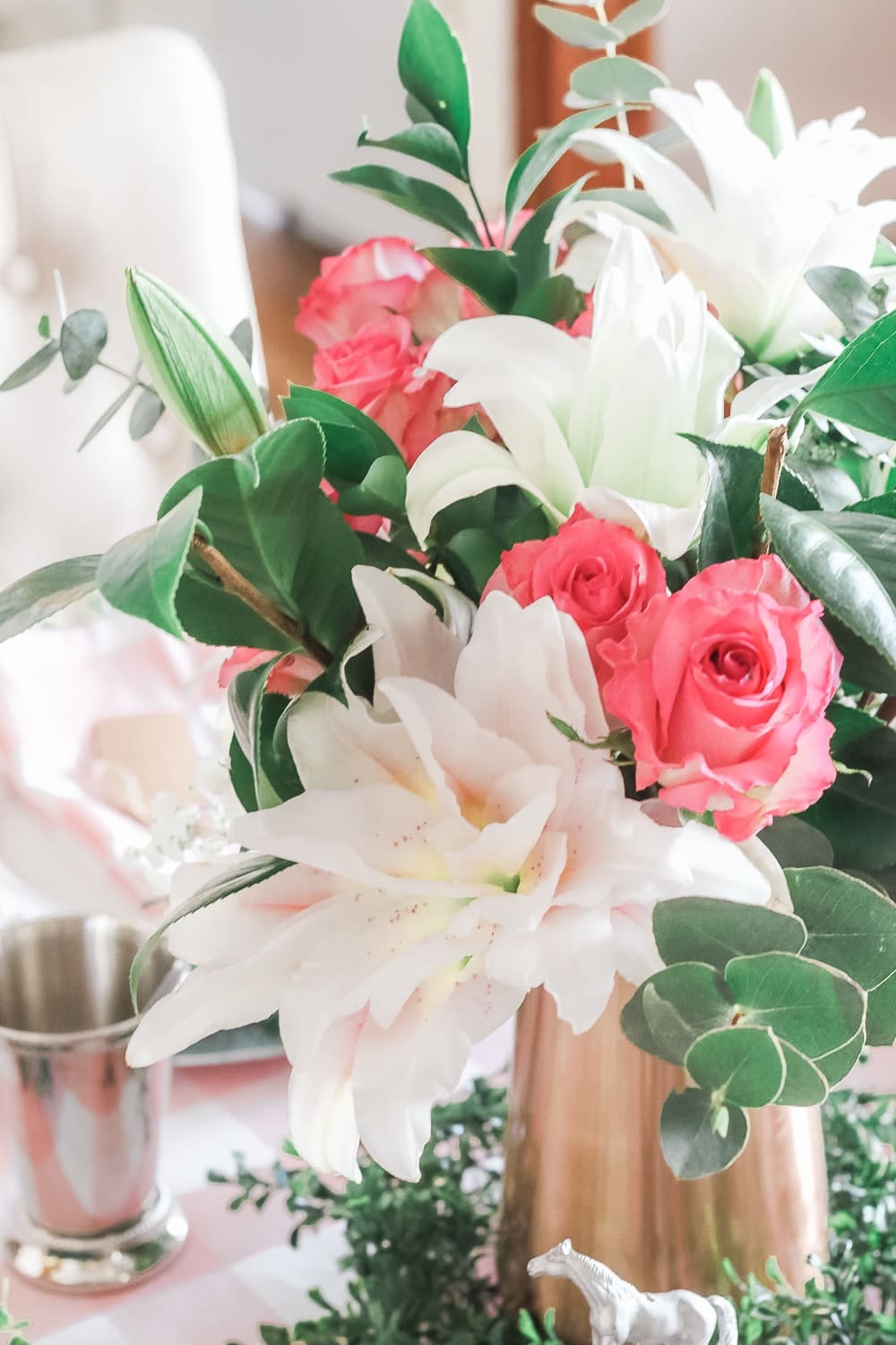 Kentucky Derby party flower arrangement created with pink roses, white rose lilies, greenery, and baby's breath by entertaining blogger Stephanie Ziajka on Diary of a Debutante
