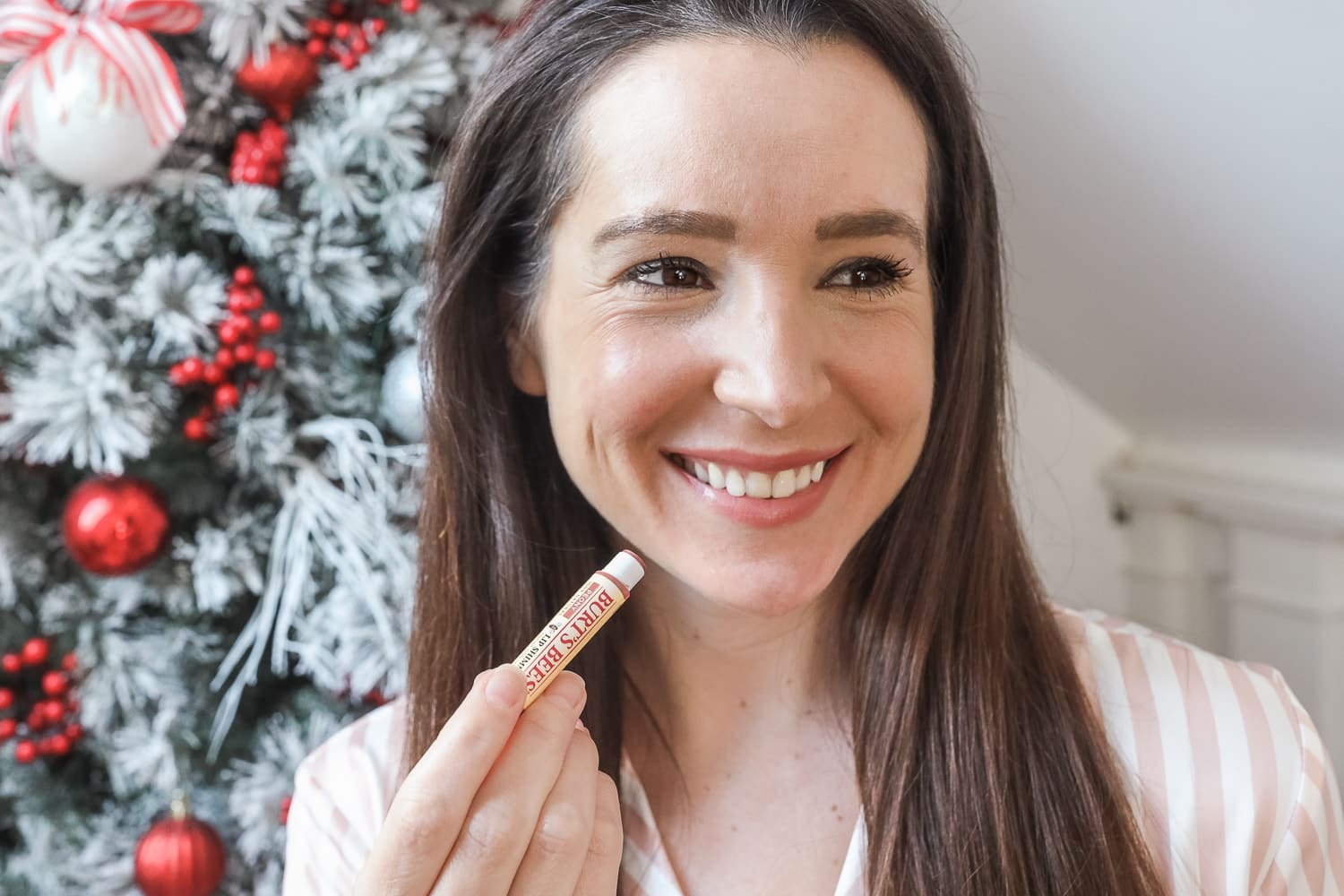 Blogger Stephanie Ziajka tests the Peony Lip Shimmer from Burt's Bees Mistletoe Kiss Warm Collection on Diary of a Debutante
