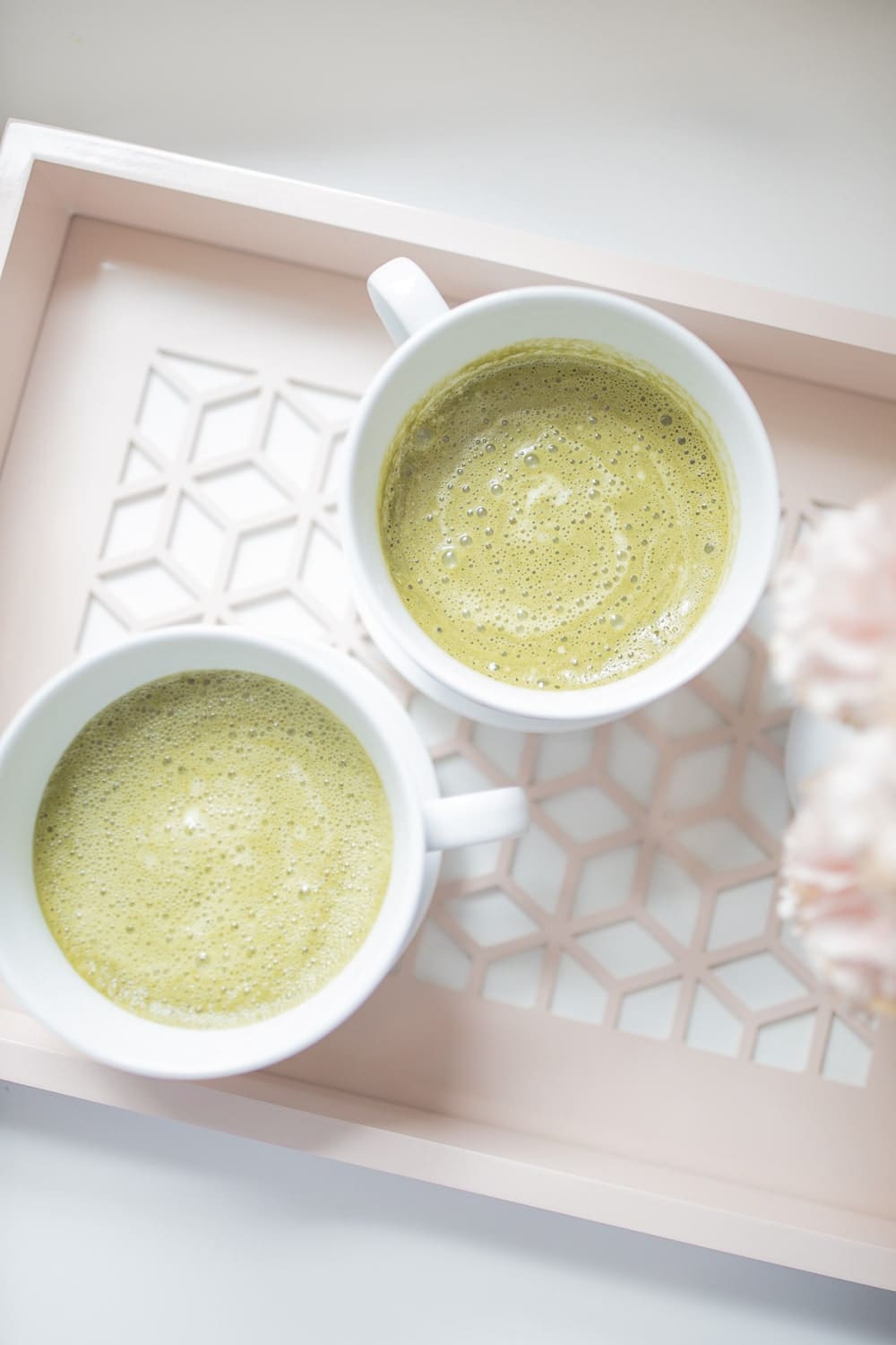 Collagen matcha lattes on a pink tray photographed by blogger Stephanie Ziajka on Diary of a Debutante