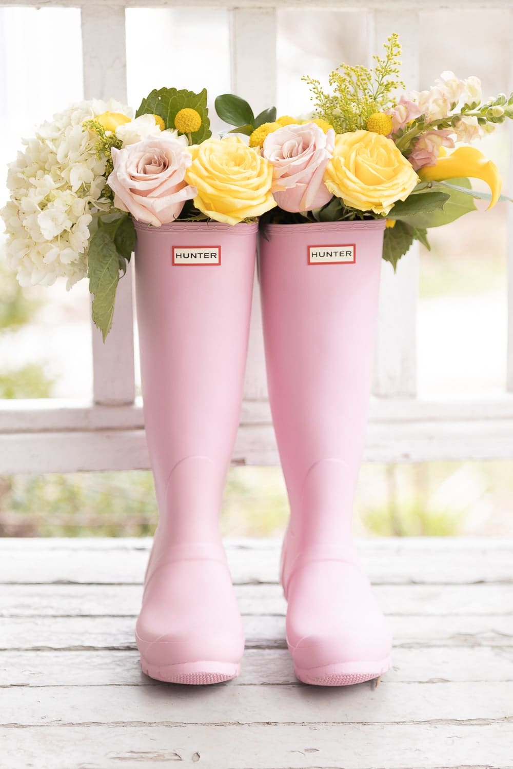 Blogger Stephanie Ziajka shares pink Hunter Boots filled with flowers, along with tips on how to clean Hunter Boots and a Hunter Boot sizing guide, on Diary of a Debutante